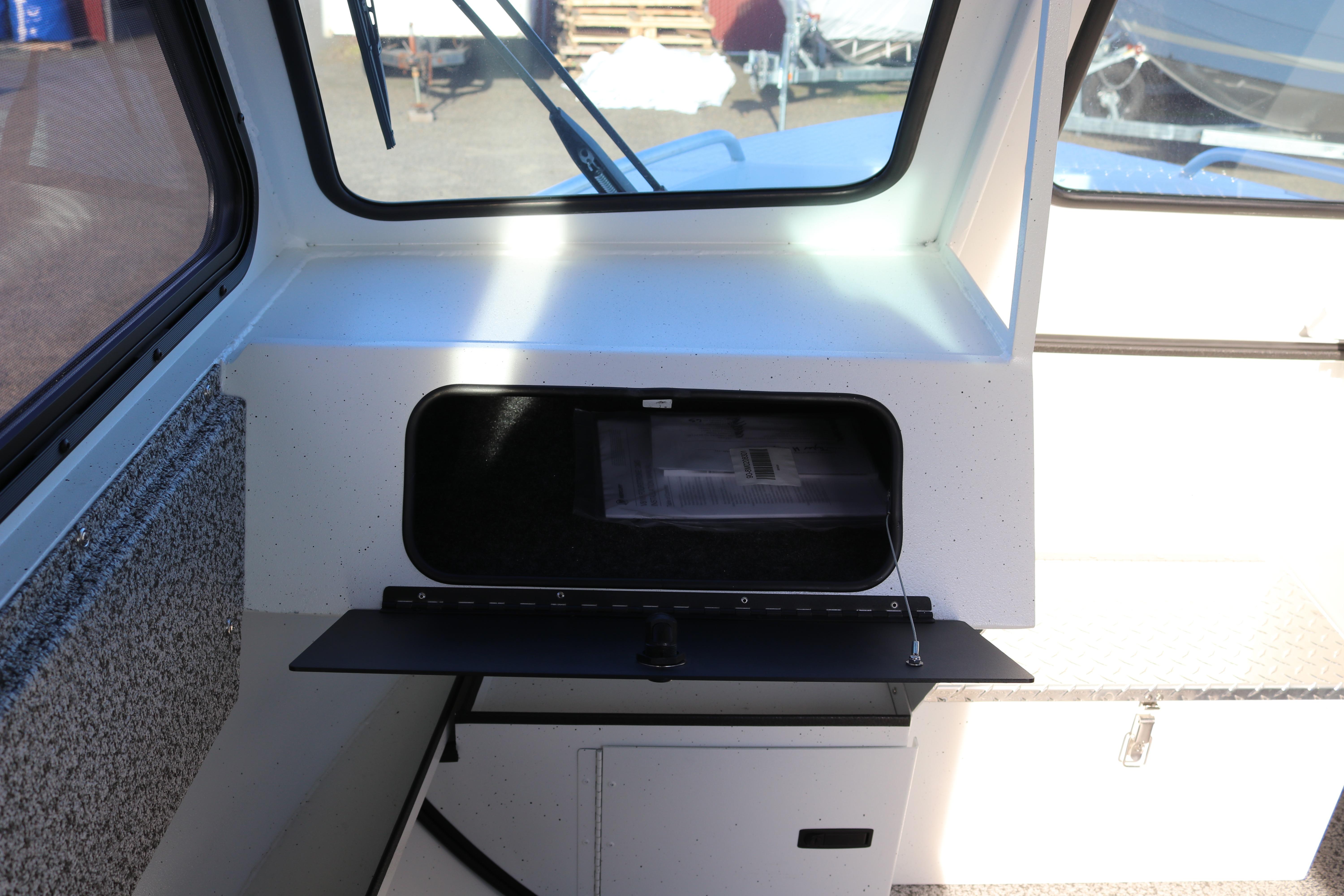 2026 Alumaweld Intruder Outboard 22 interior with open storage compartment.