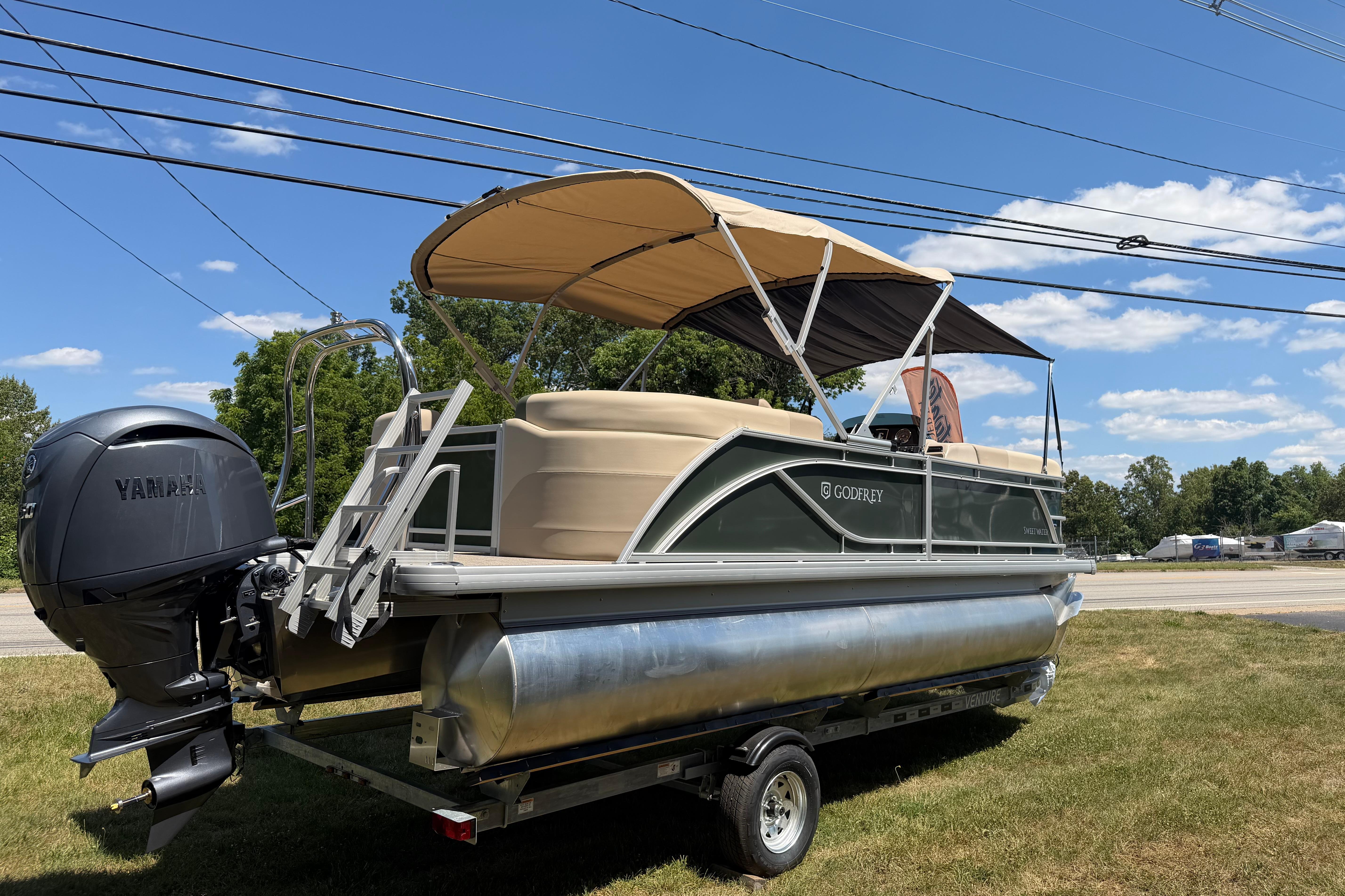2026 Godfrey SW 2086 SBC pontoon boat with Yamaha motor on trailer, parked on grass.