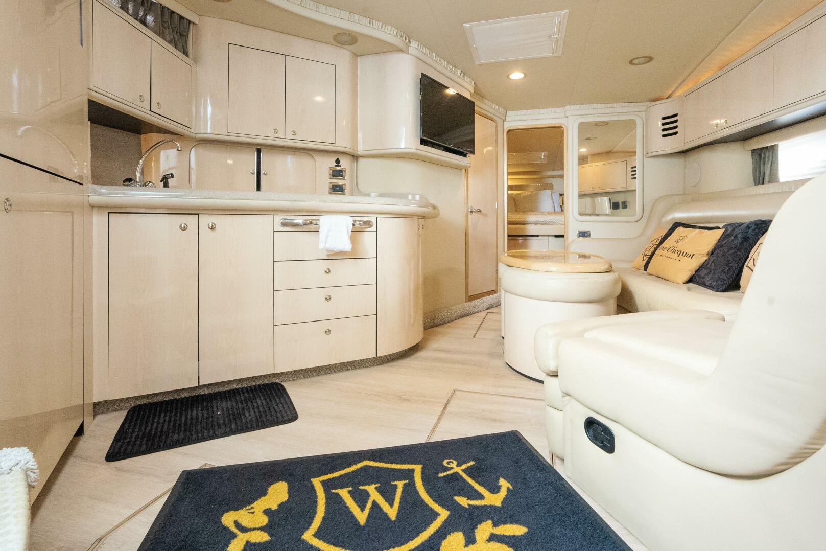 Luxurious interior of 2003 Sea Ray Sundancer 460 yacht with modern kitchen and seating area.