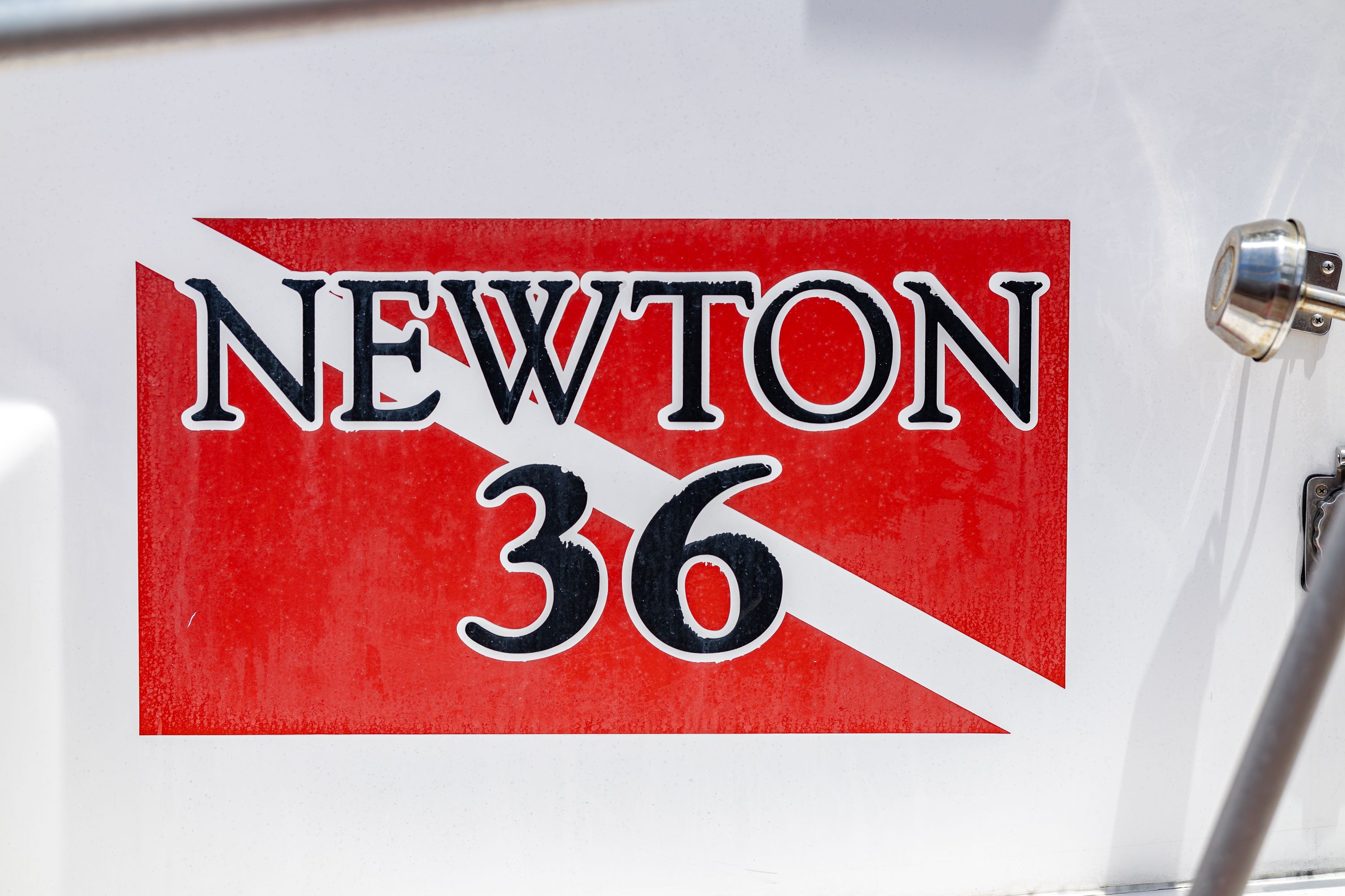 Close-up of the "Newton 36" logo on a boat.