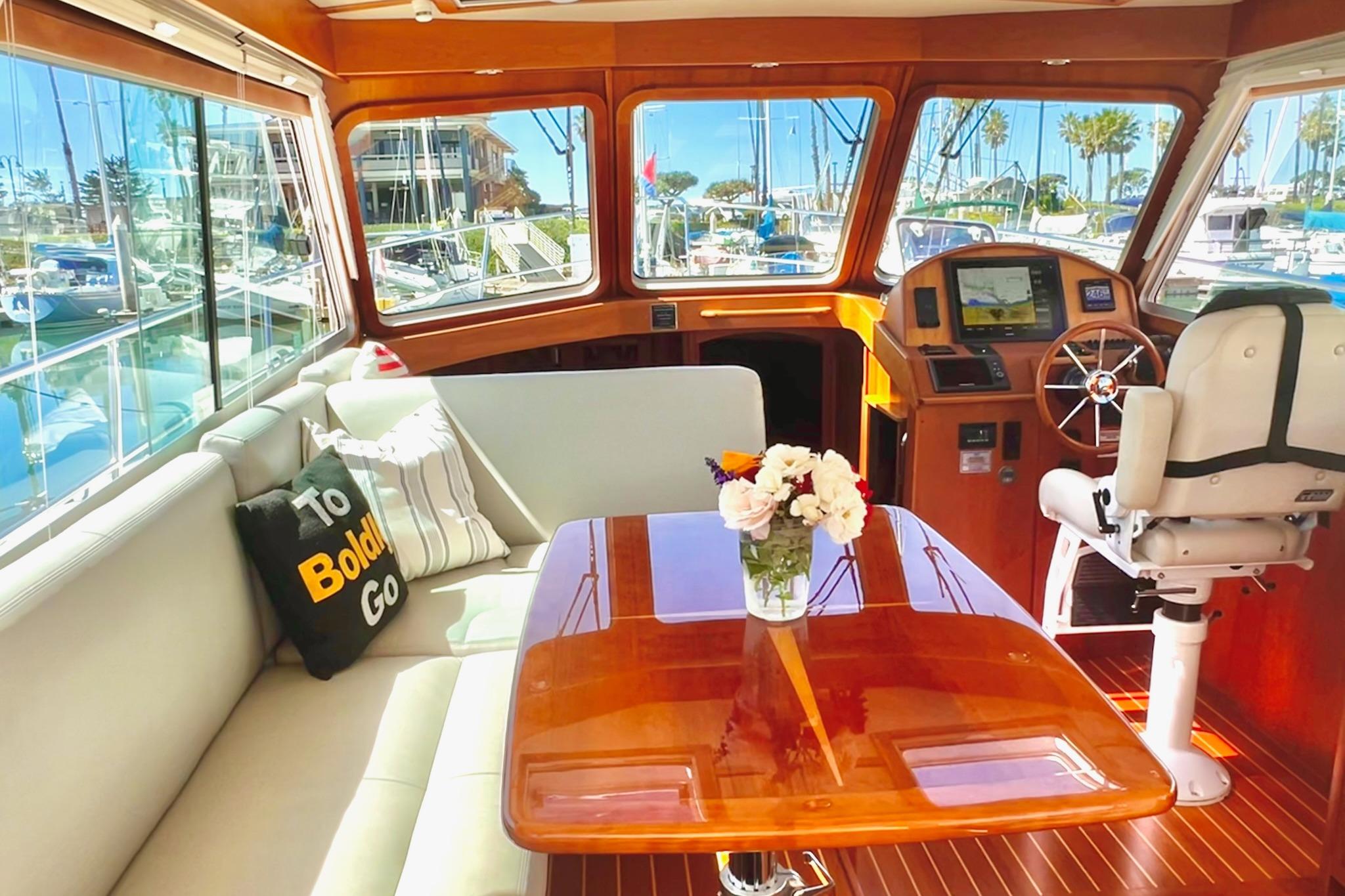 Luxurious interior of 2016 Sabre 38 Salon Express yacht with elegant seating and helm.