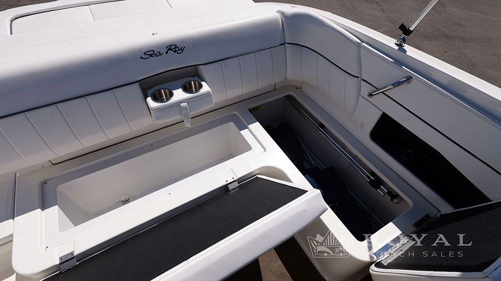 The image shows the cockpit of a Sea Ray SLX 230 boat with seating and cup holders.