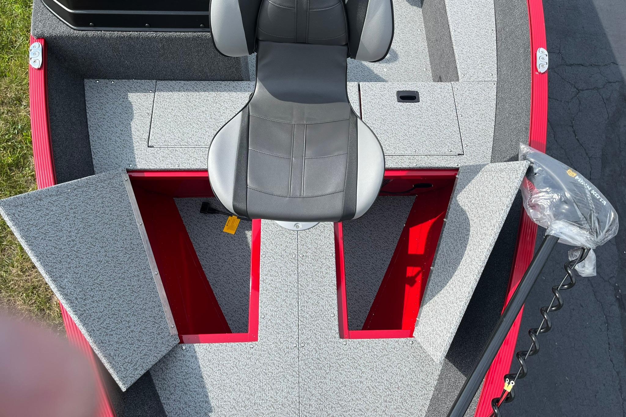 2026 Lund 1650 Angler SS boat interior with open storage compartments and seating.