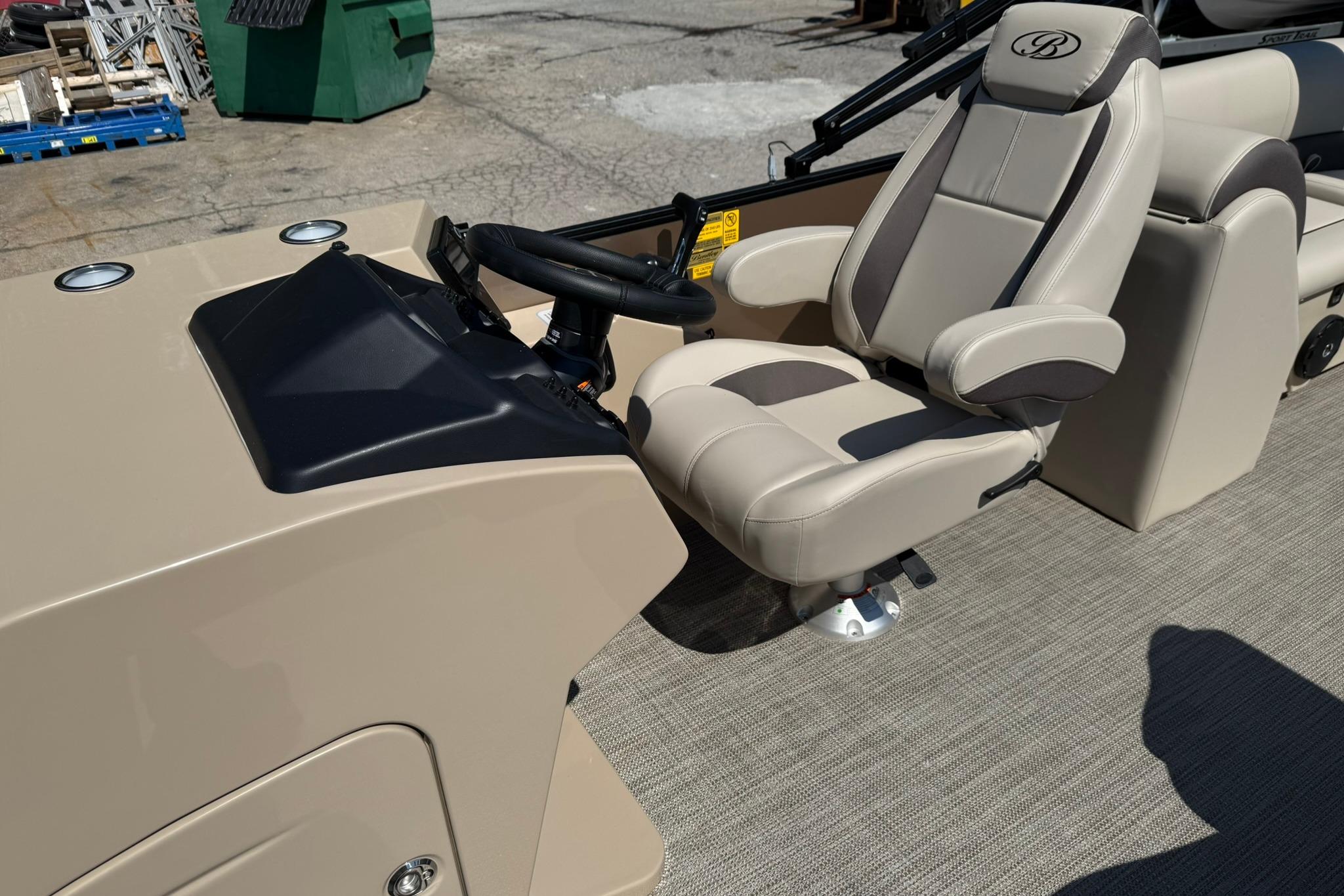 2025 Bentley Pontoons Legacy 243 Navigator helm with beige captain's chair and steering wheel.