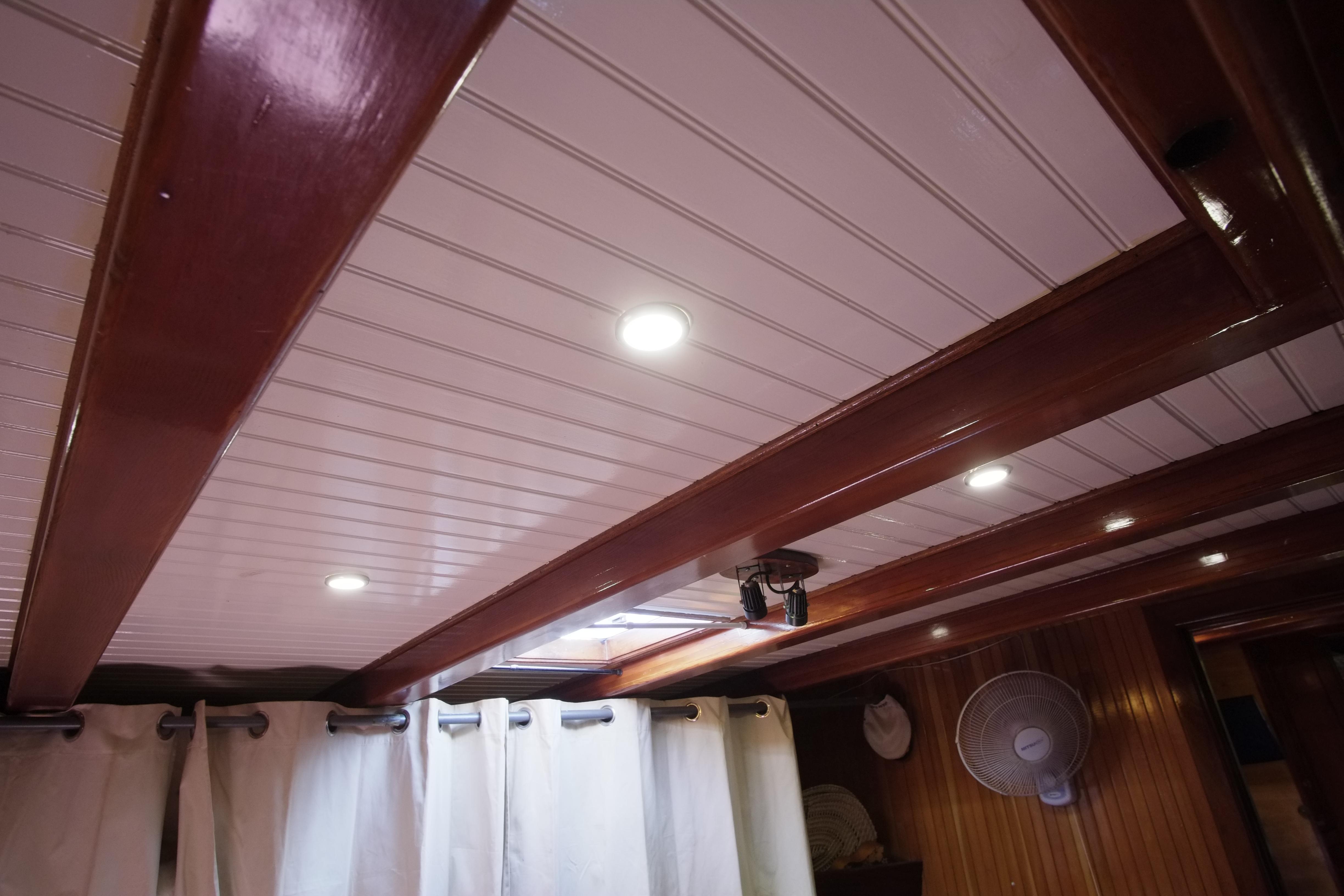 Interior ceiling of 2006 Custom Bud Macintosh schooner with wooden beams and recessed lighting.