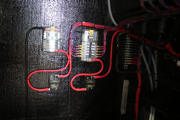 Electrical wiring setup in a 2025 East Cape 25 Open boat, featuring circuit breakers and fuses.