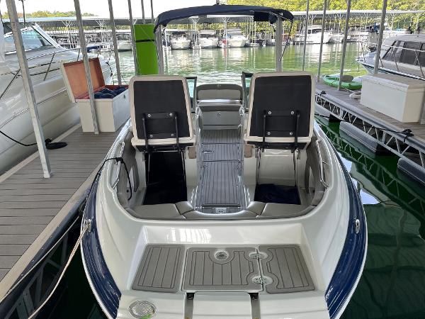 2019 Crownline E255 boat docked, featuring spacious seating and sleek design.