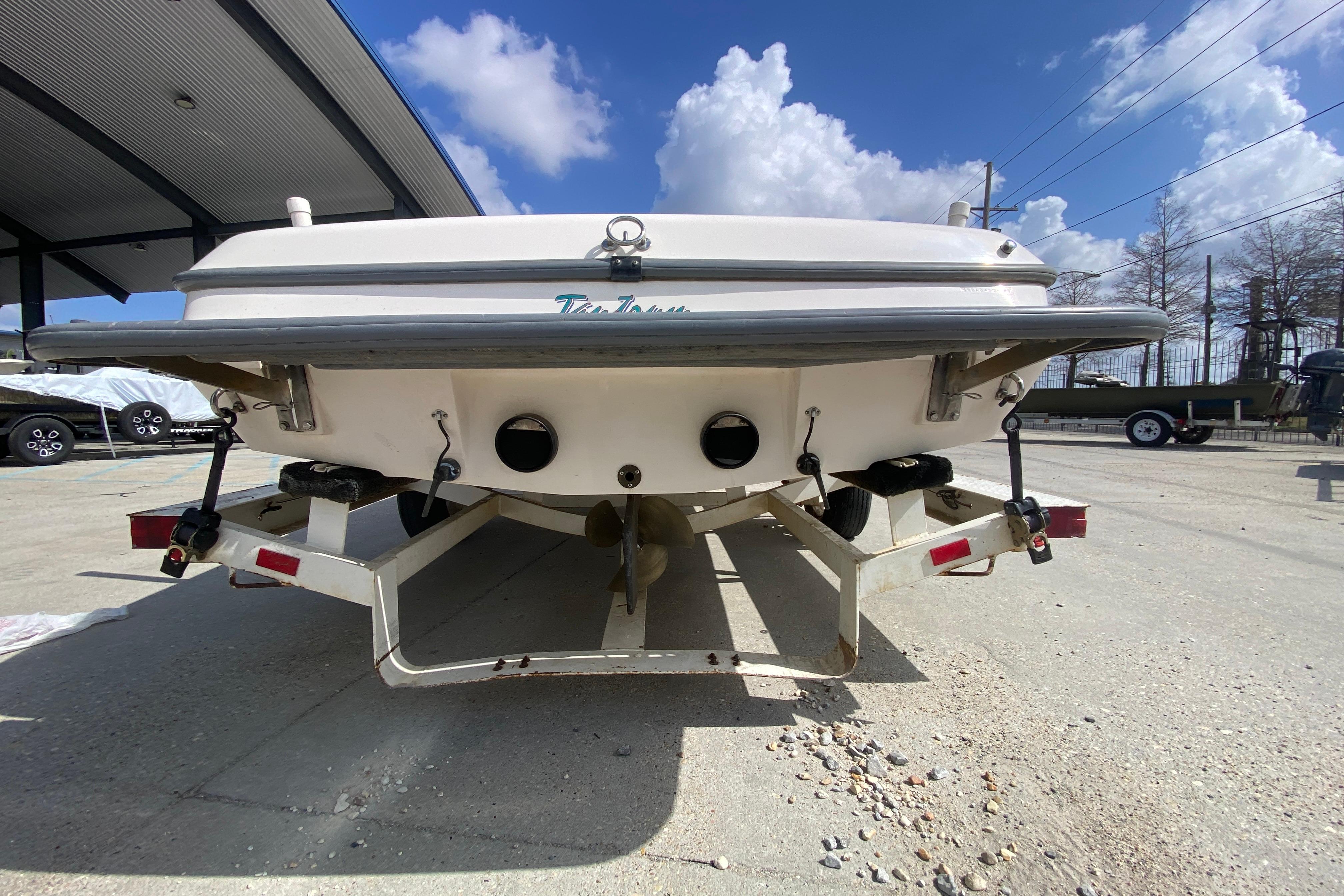 1997 Malibu Tantrum boat on trailer under clear blue sky.