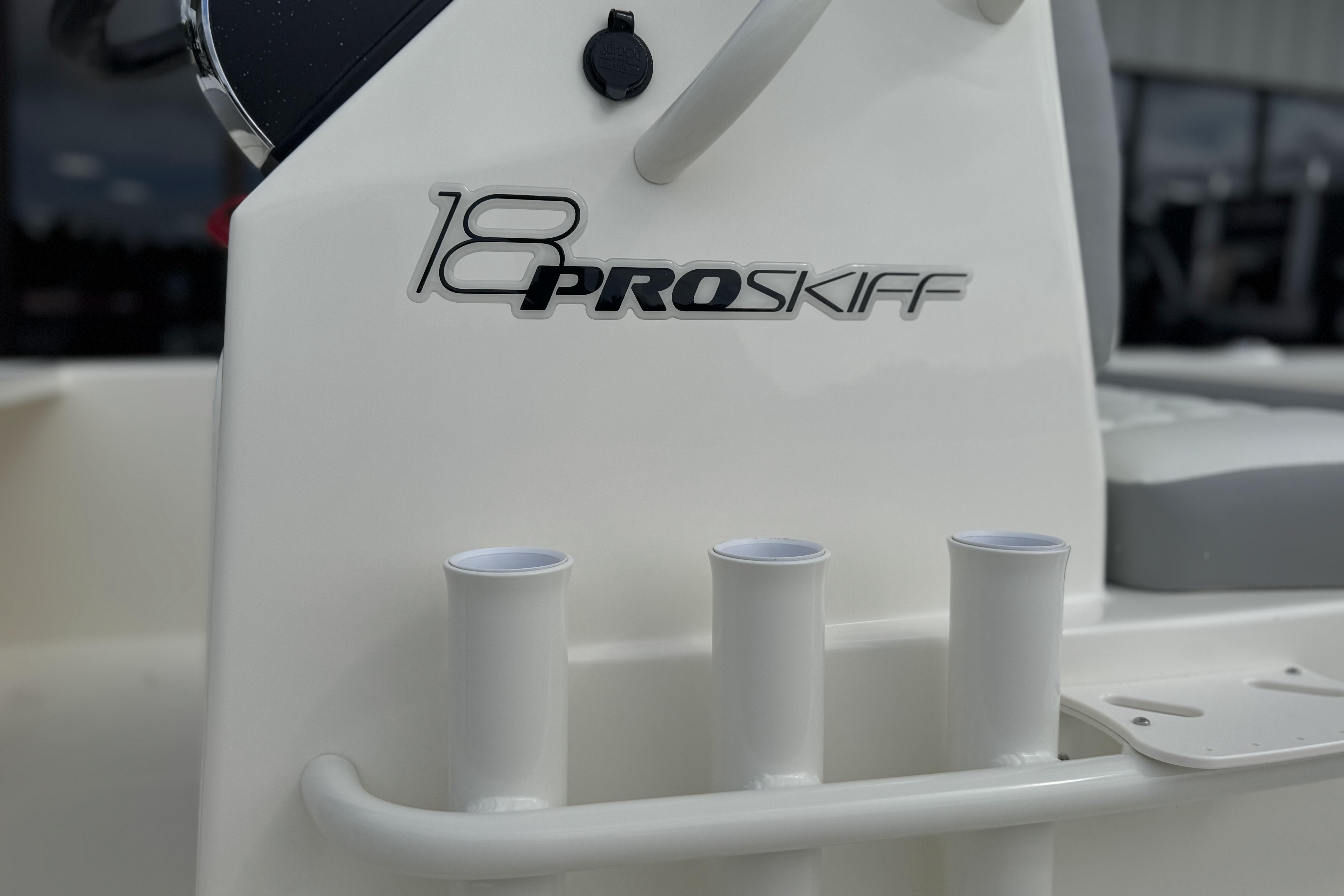 2026 Mako 18 Pro Skiff boat console with rod holders and logo detail.
