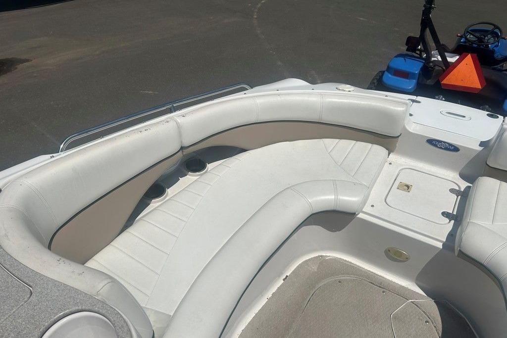 2006 Four Winns 244 Funship boat interior with white seating and cup holders.