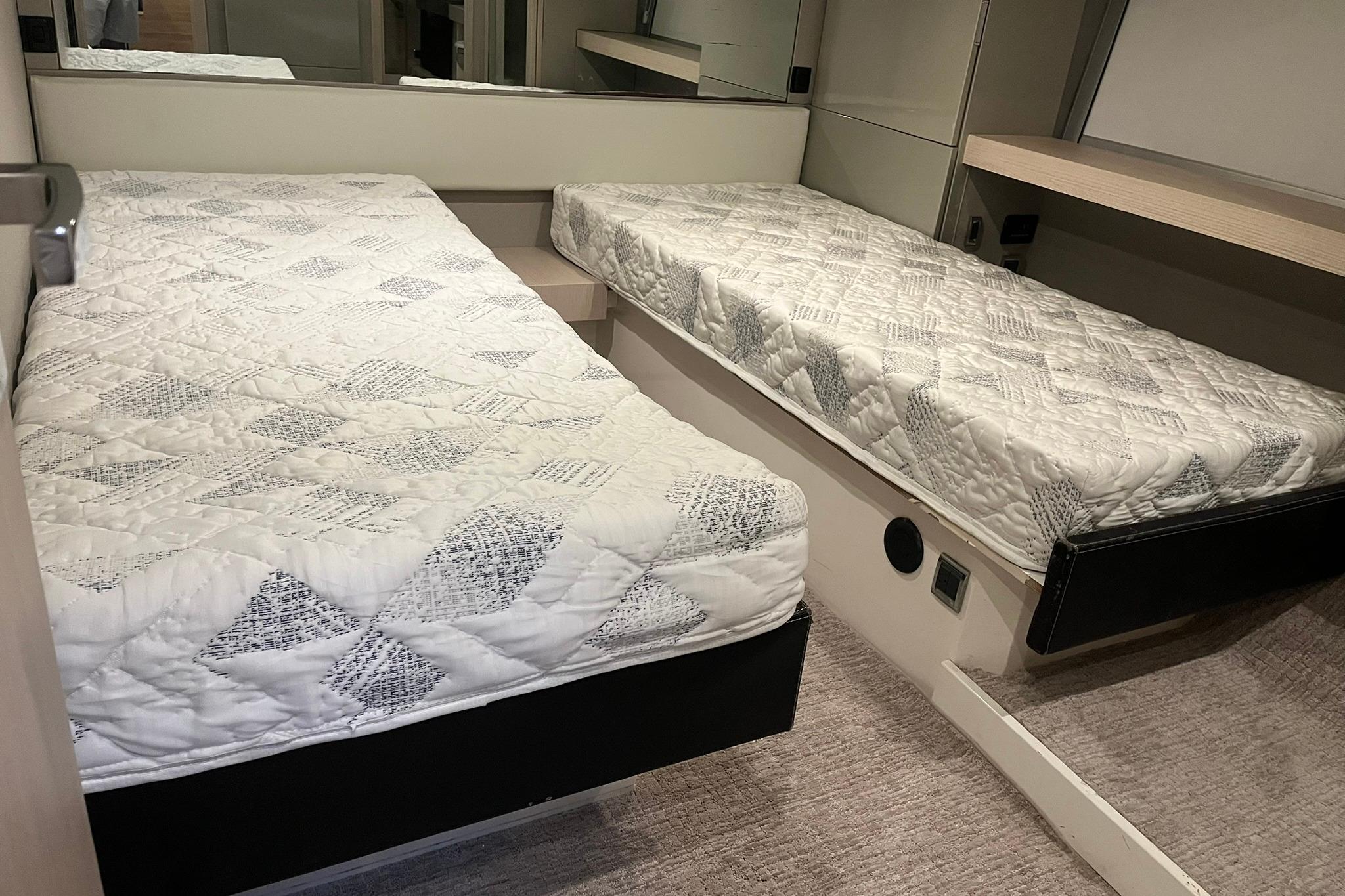Twin beds in a 2012 Fairline Targa 58 Gran Turismo yacht cabin.