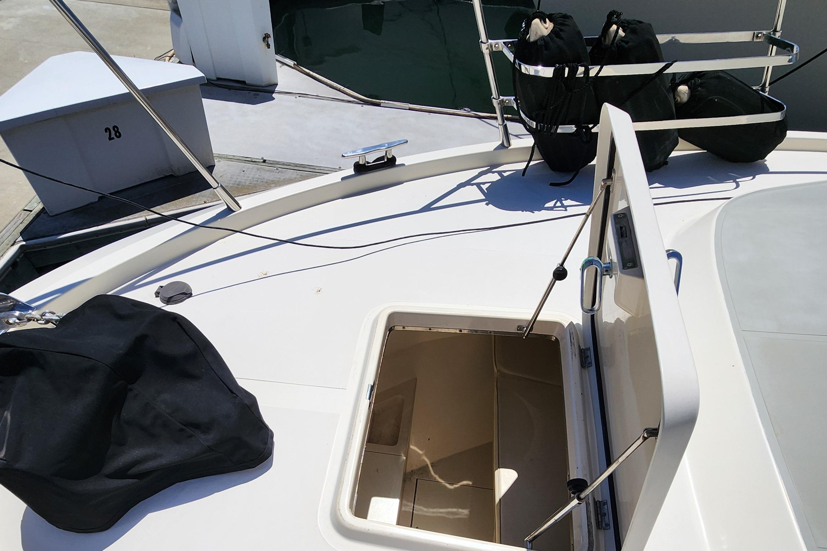 1987 Riva SuperAmerica yacht deck with open hatch and docked setting.