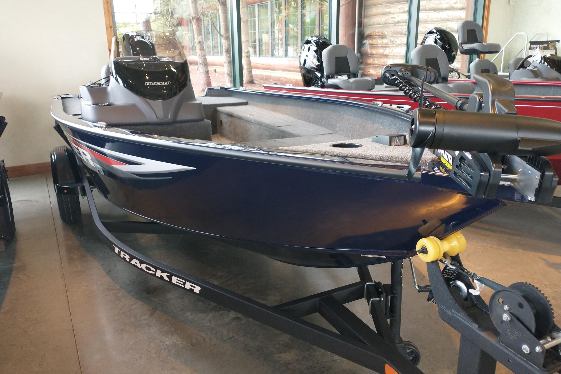2026 Tracker Super Guide V-16 SC boat displayed indoors on a trailer.