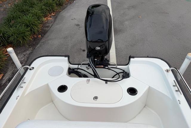 2016 Boston Whaler 150 Montauk boat stern view with outboard motor and seating.