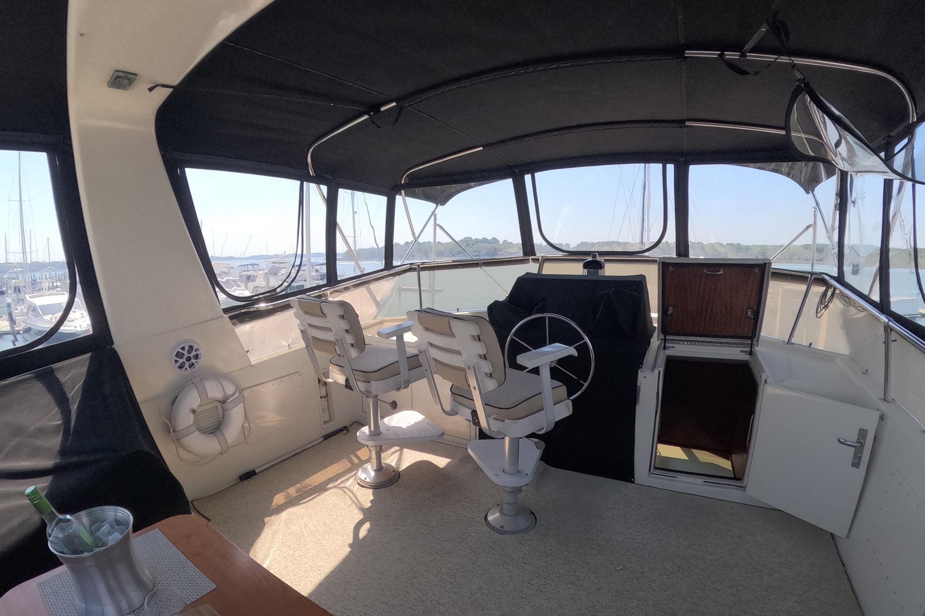 Interior view of 1987 Hatteras 54 Motor Yacht helm with seating and controls.
