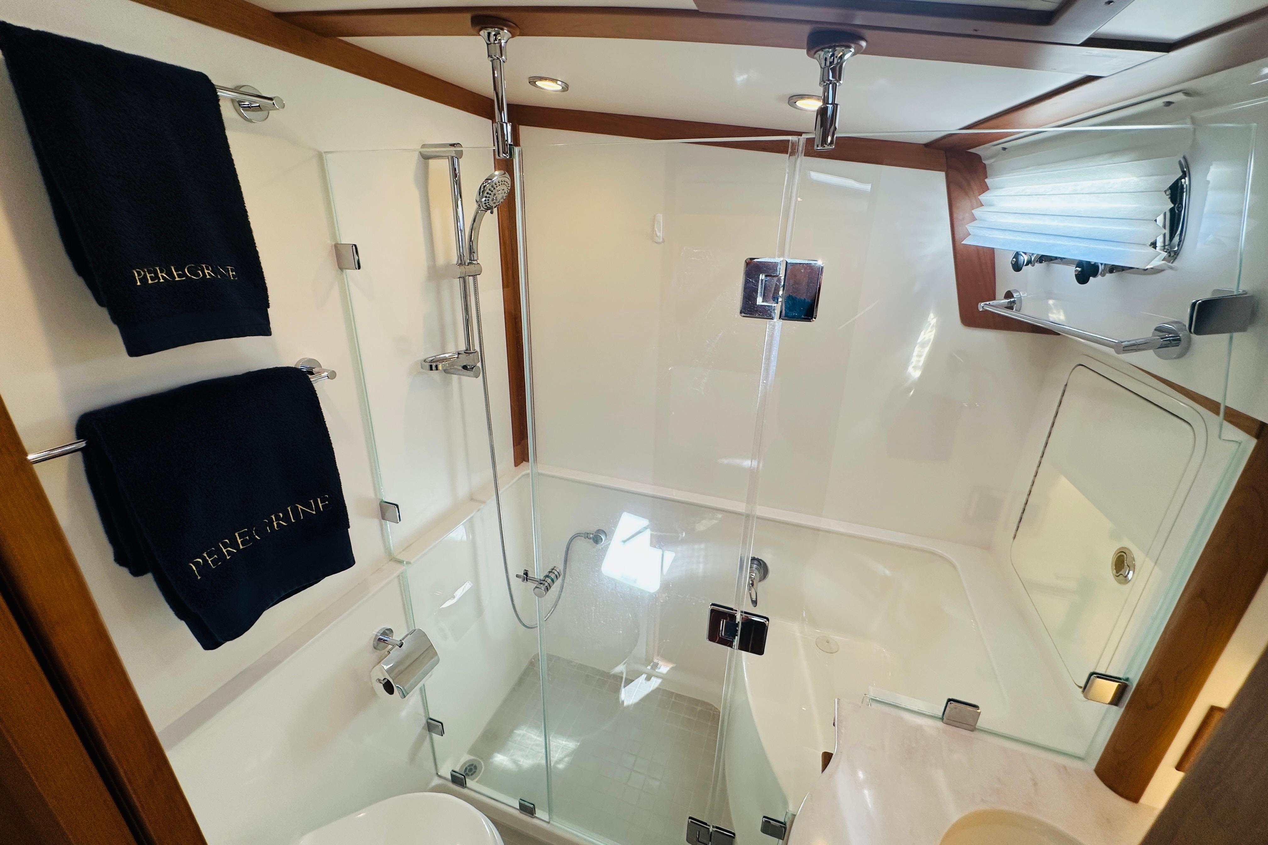 Luxurious bathroom in 2025 Sabre 48 Salon Express yacht with glass shower enclosure.