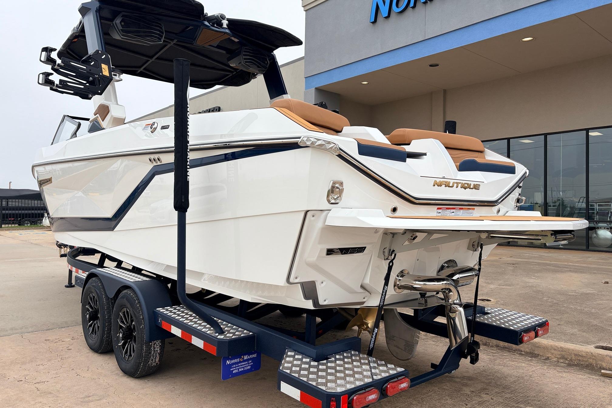 2026 Nautique Super Air Nautique G25 boat on trailer outside dealership.
