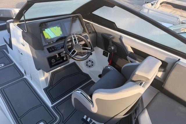 2023 Cobalt R6 Surf boat cockpit with modern steering and navigation system.