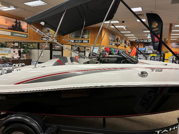 2023 Tahoe T16 boat on display in a showroom with accessories.
