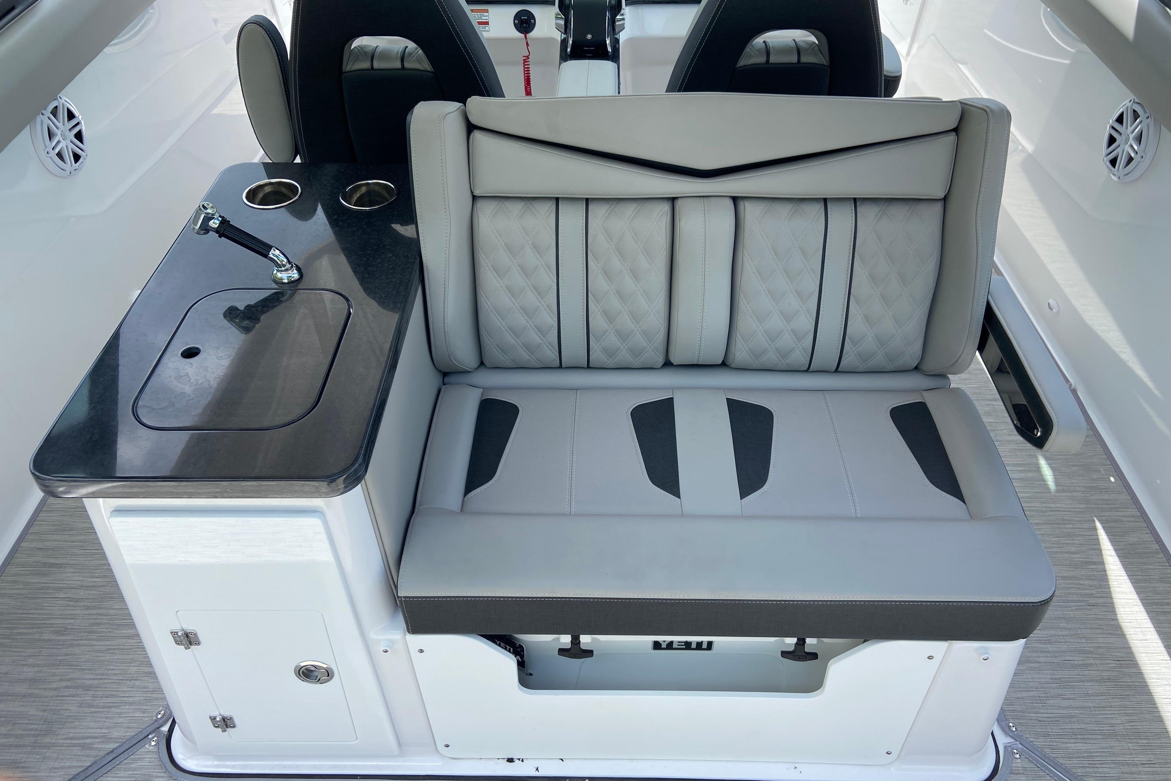 Luxurious seating and kitchenette on 2026 Monterey Elite 30 OB boat.
