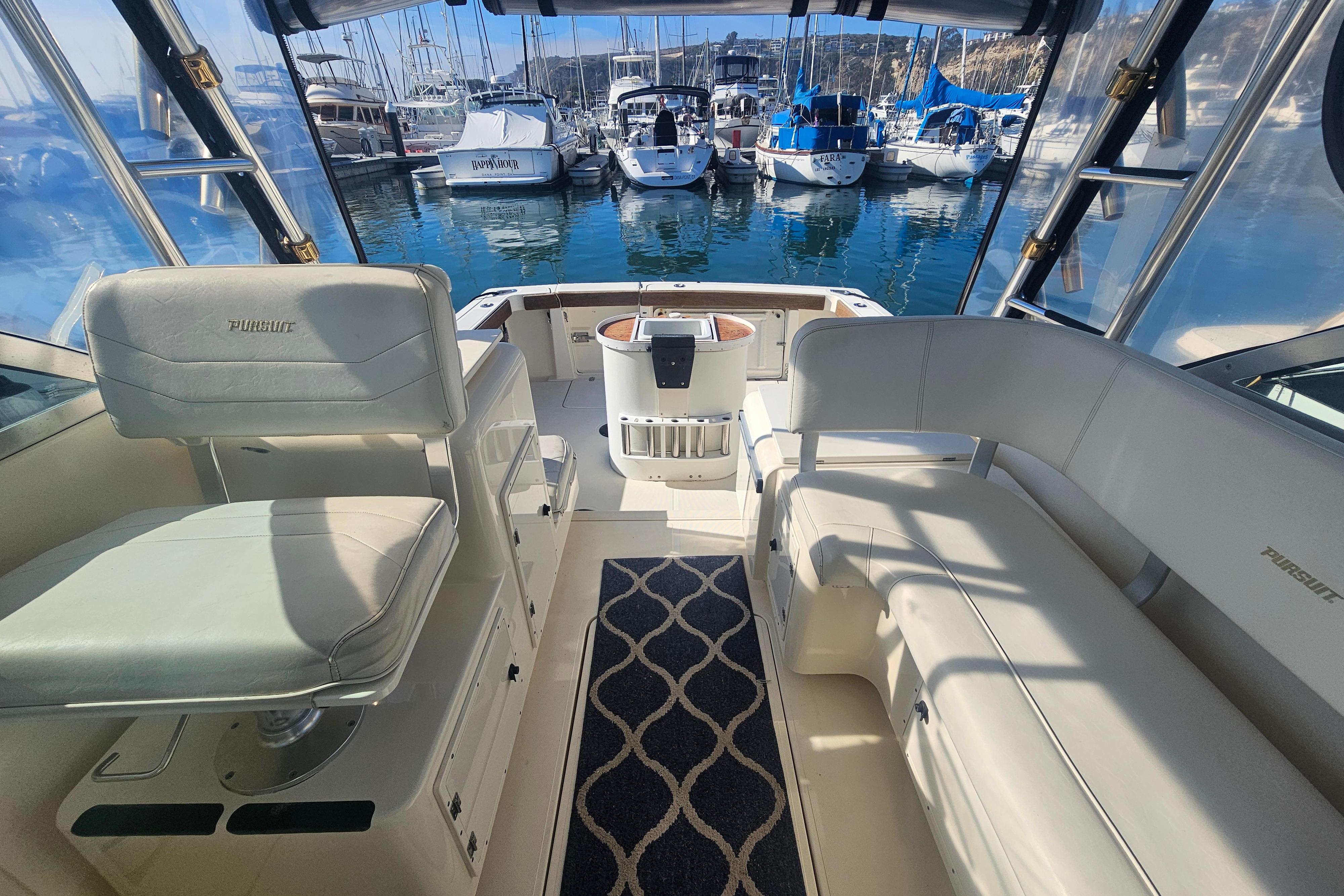 2001 Pursuit 3000 Express boat interior with seating, docked at marina.