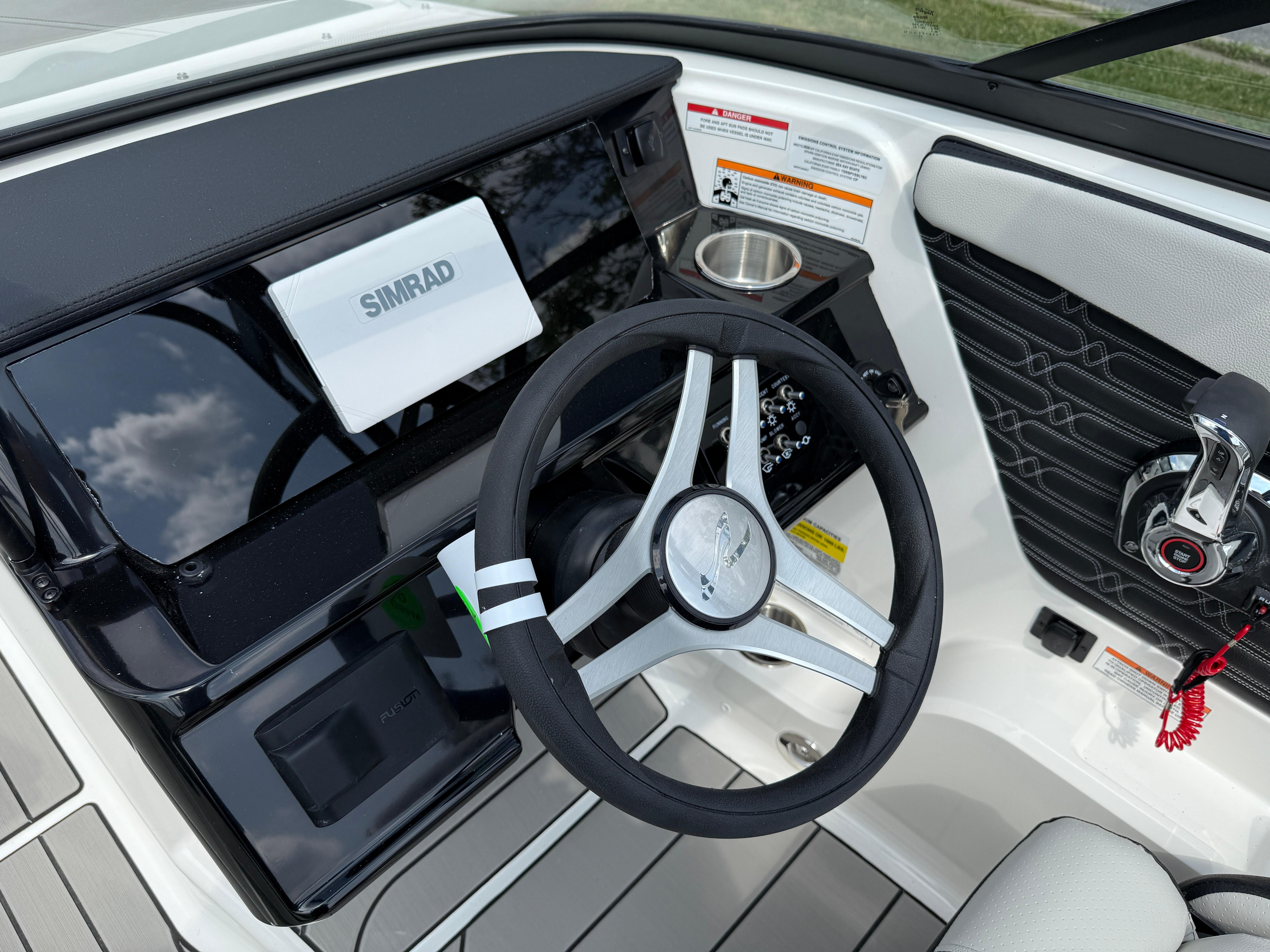 2026 Sea Ray SPX 210 Outboard dashboard with steering wheel and Simrad display.