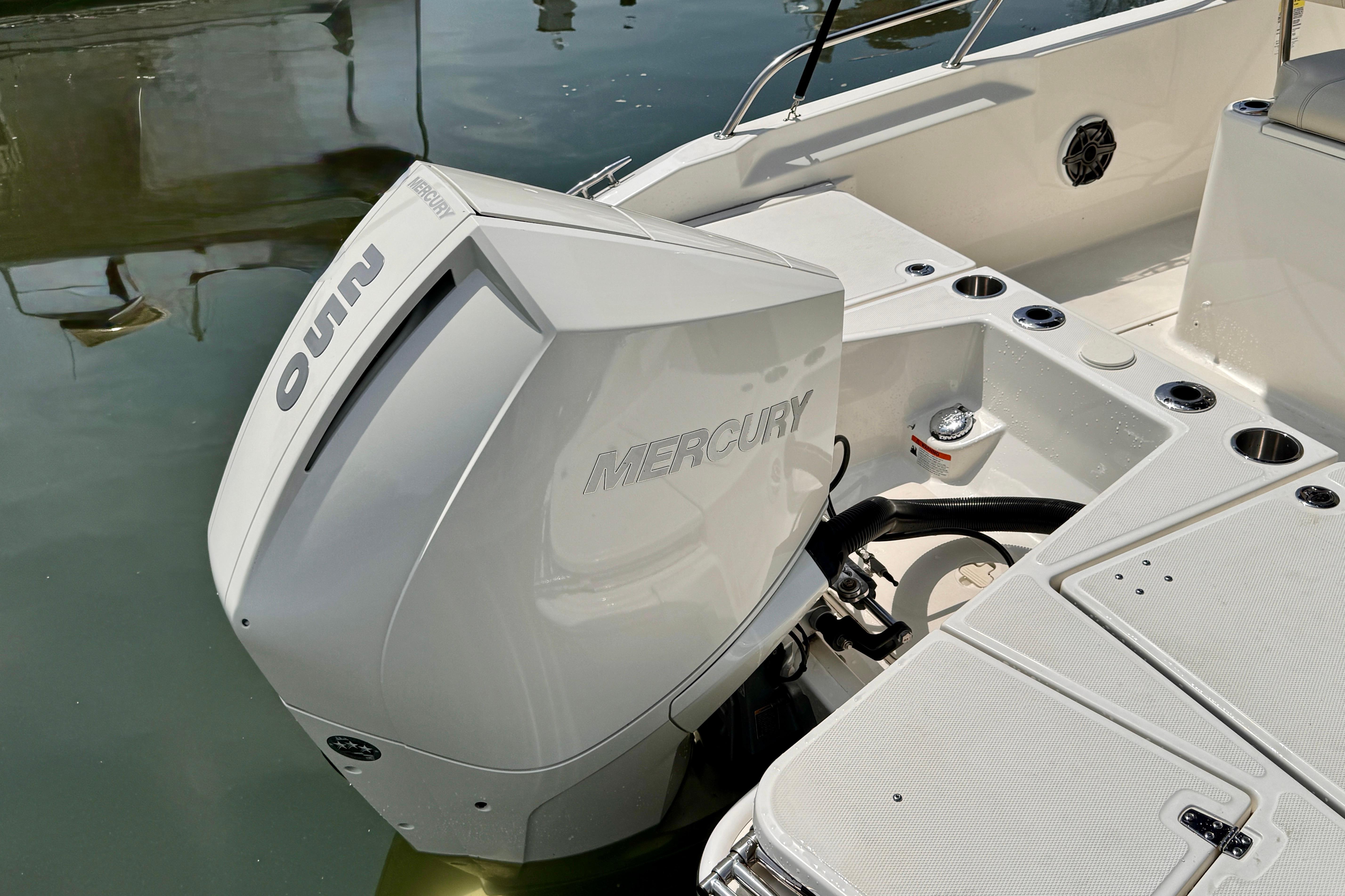 2022 Boston Whaler 220 Dauntless with Mercury outboard engine on calm water.