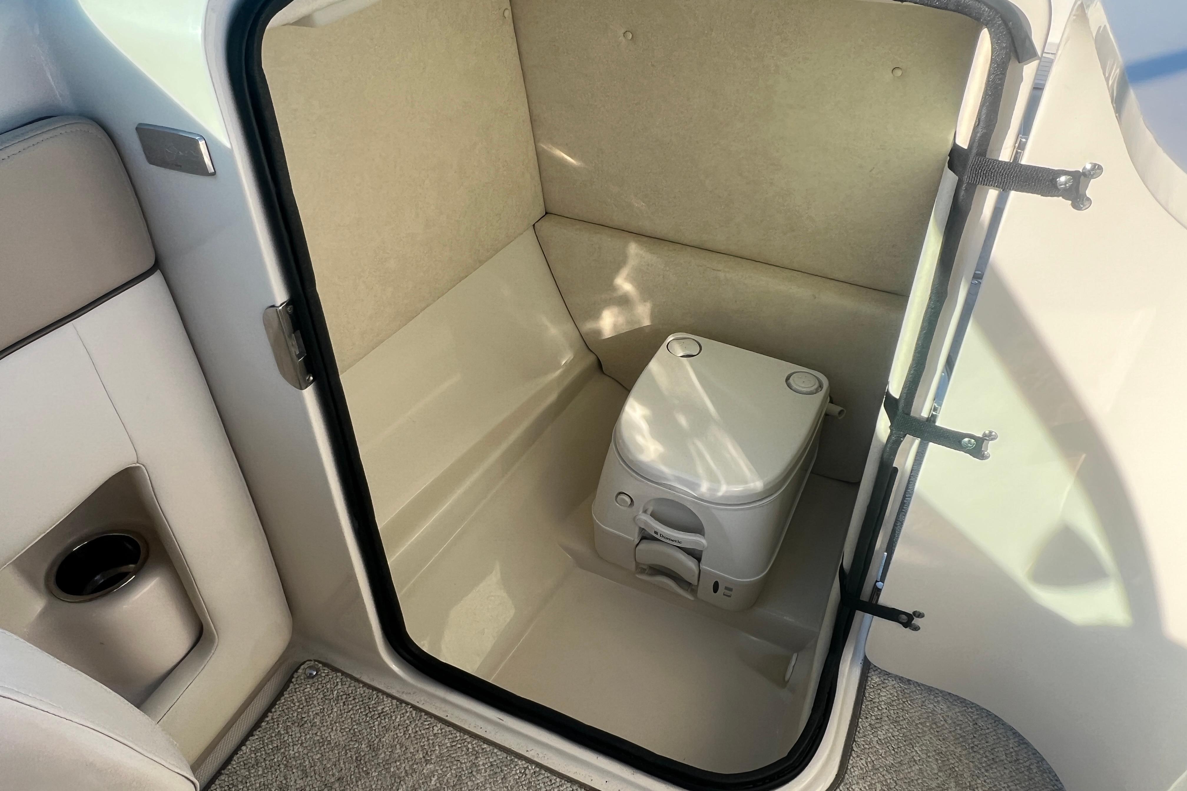 2009 Sea Ray 210 Sundeck interior with compact marine toilet.