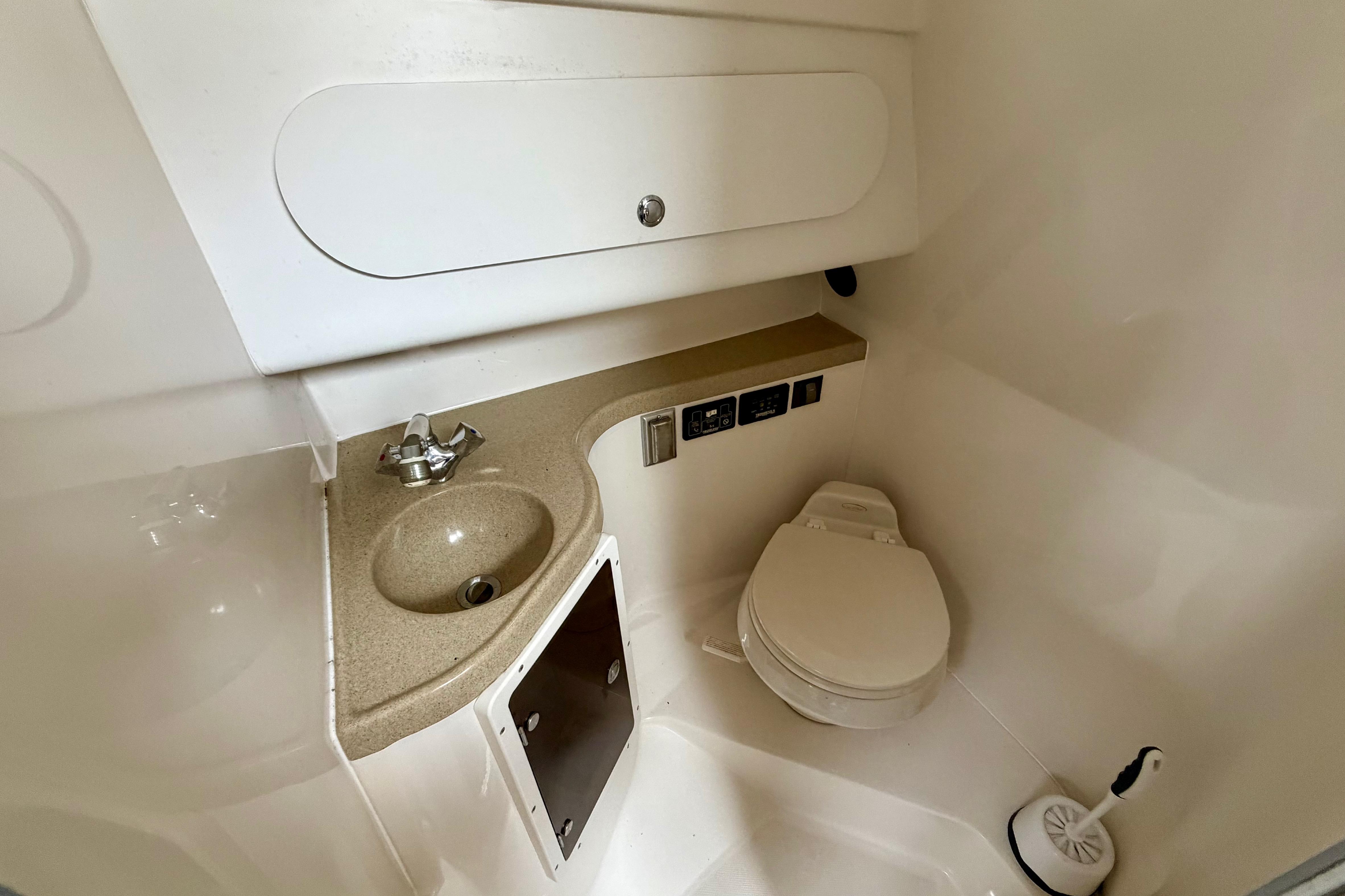 2006 Seaswirl Striper 2901 Walkaround O/B boat bathroom with sink and toilet.