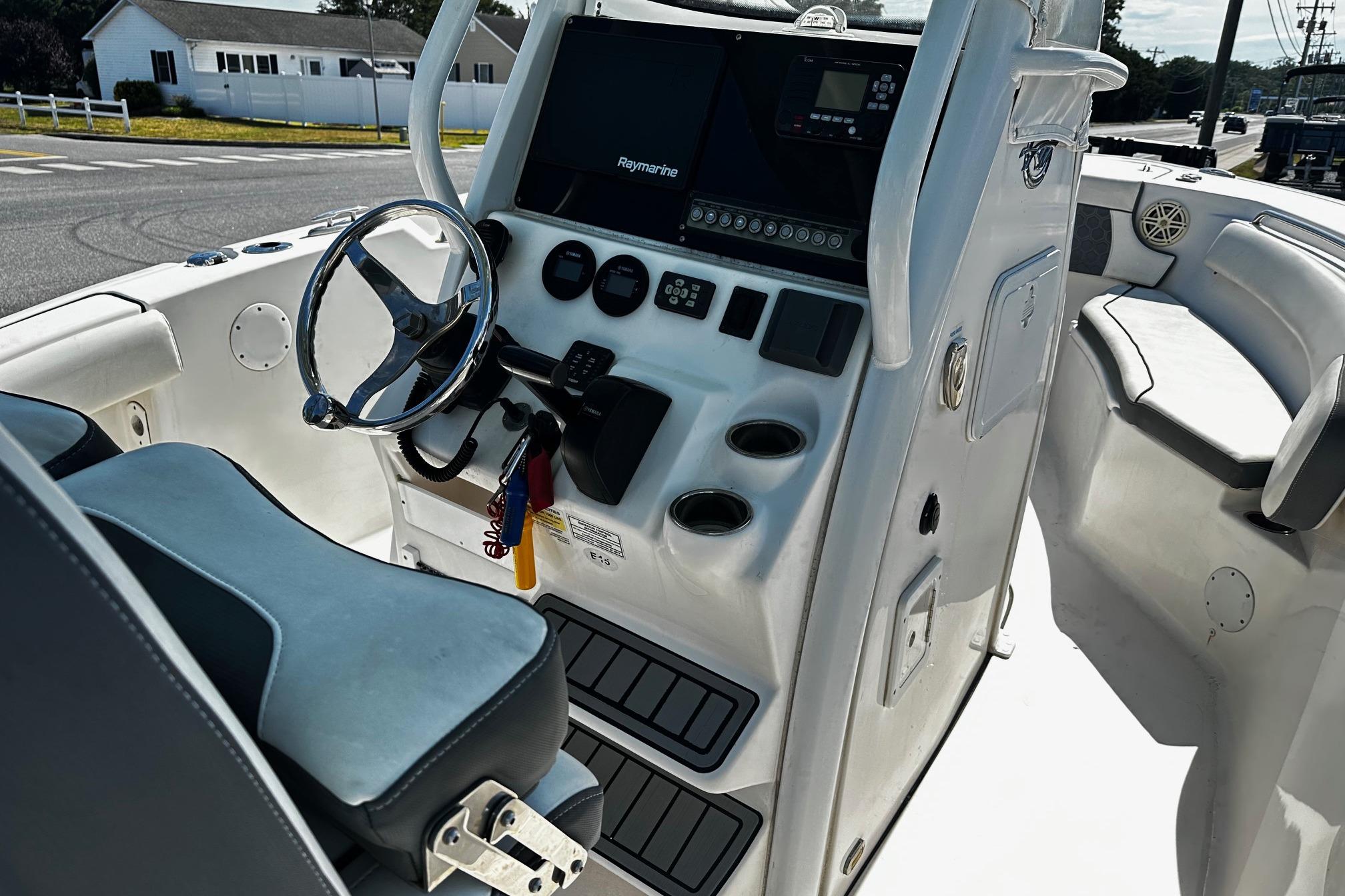 2020 Tidewater 230 CC Adventure boat cockpit with steering wheel and control panel.