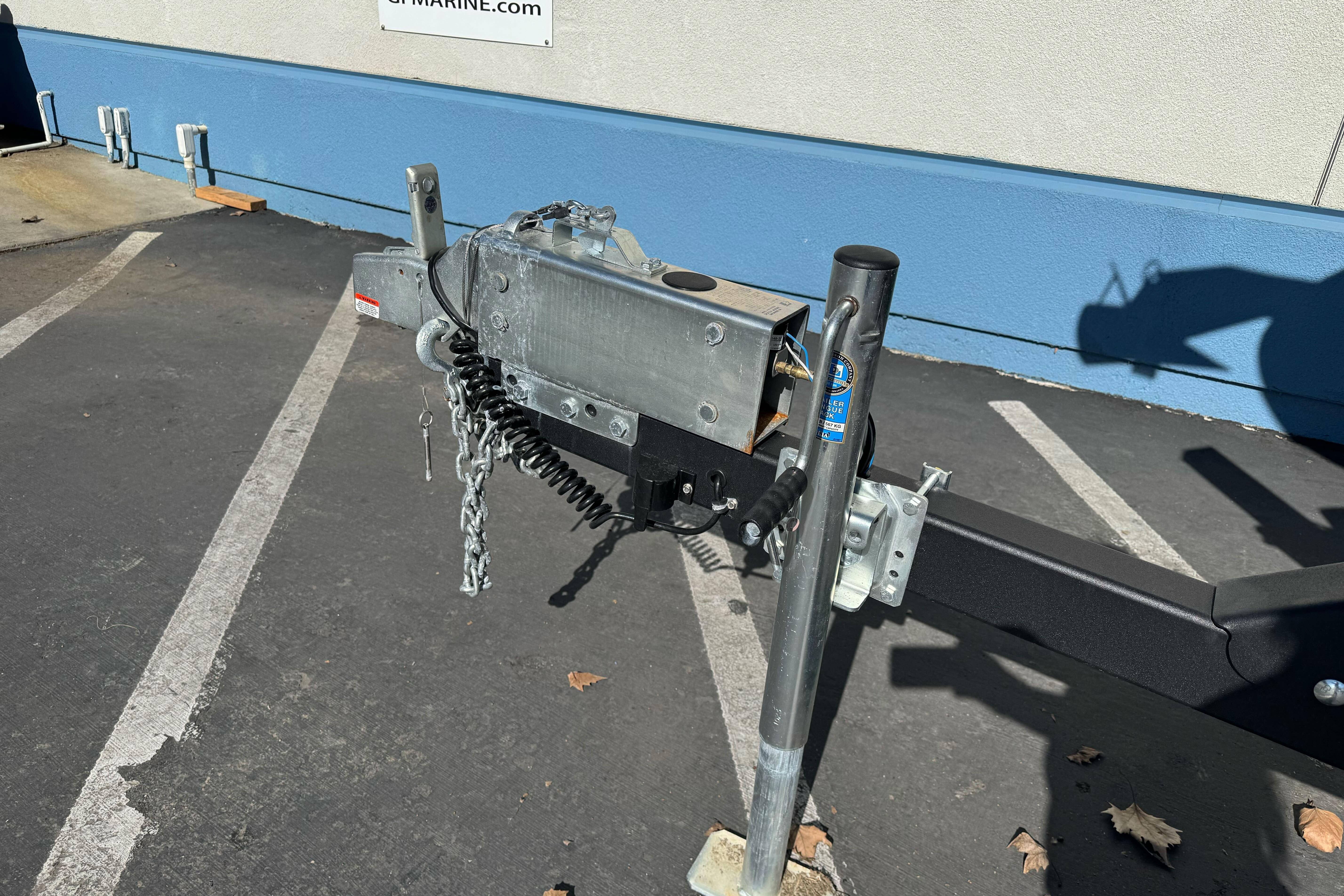 Trailer hitch for 2026 Sea Ray SLX 260 boat in parking lot.