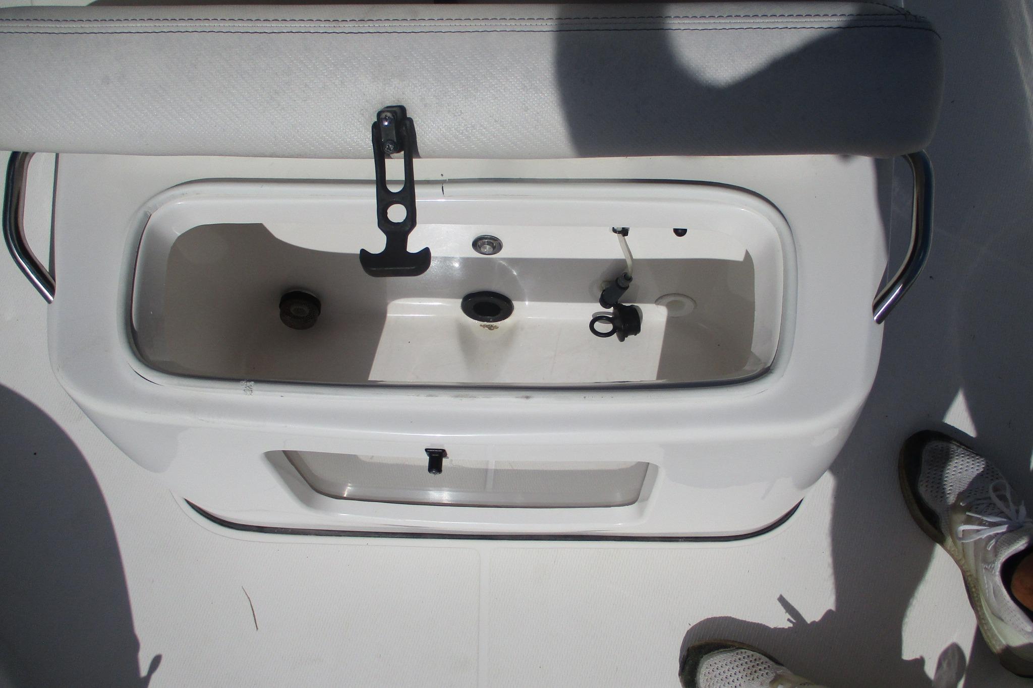 Livewell compartment on a 2021 Blue Wave 2000 PureBay boat, open and empty.