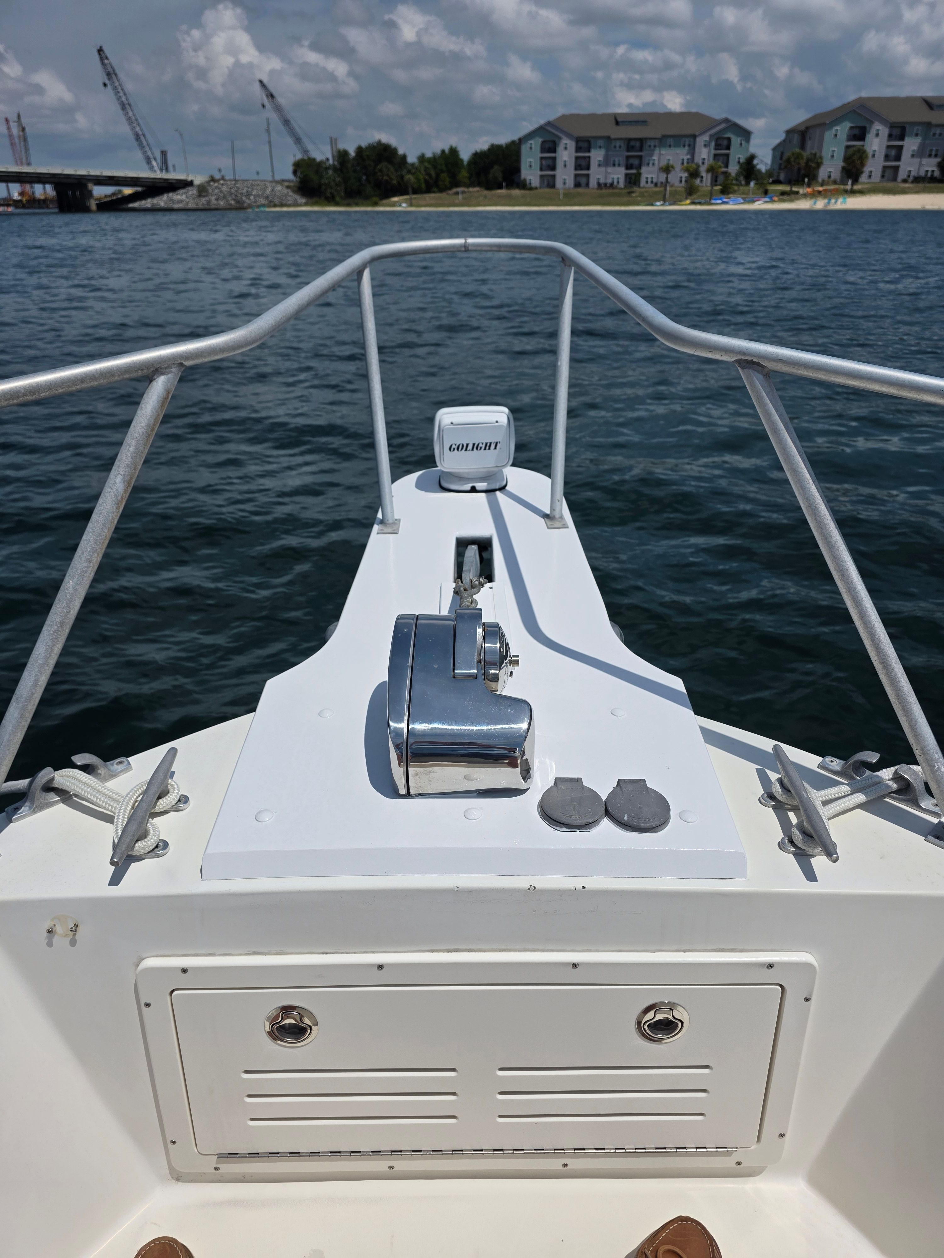 Bow view of a 1987 Mako 248 WAC boat on the water.
