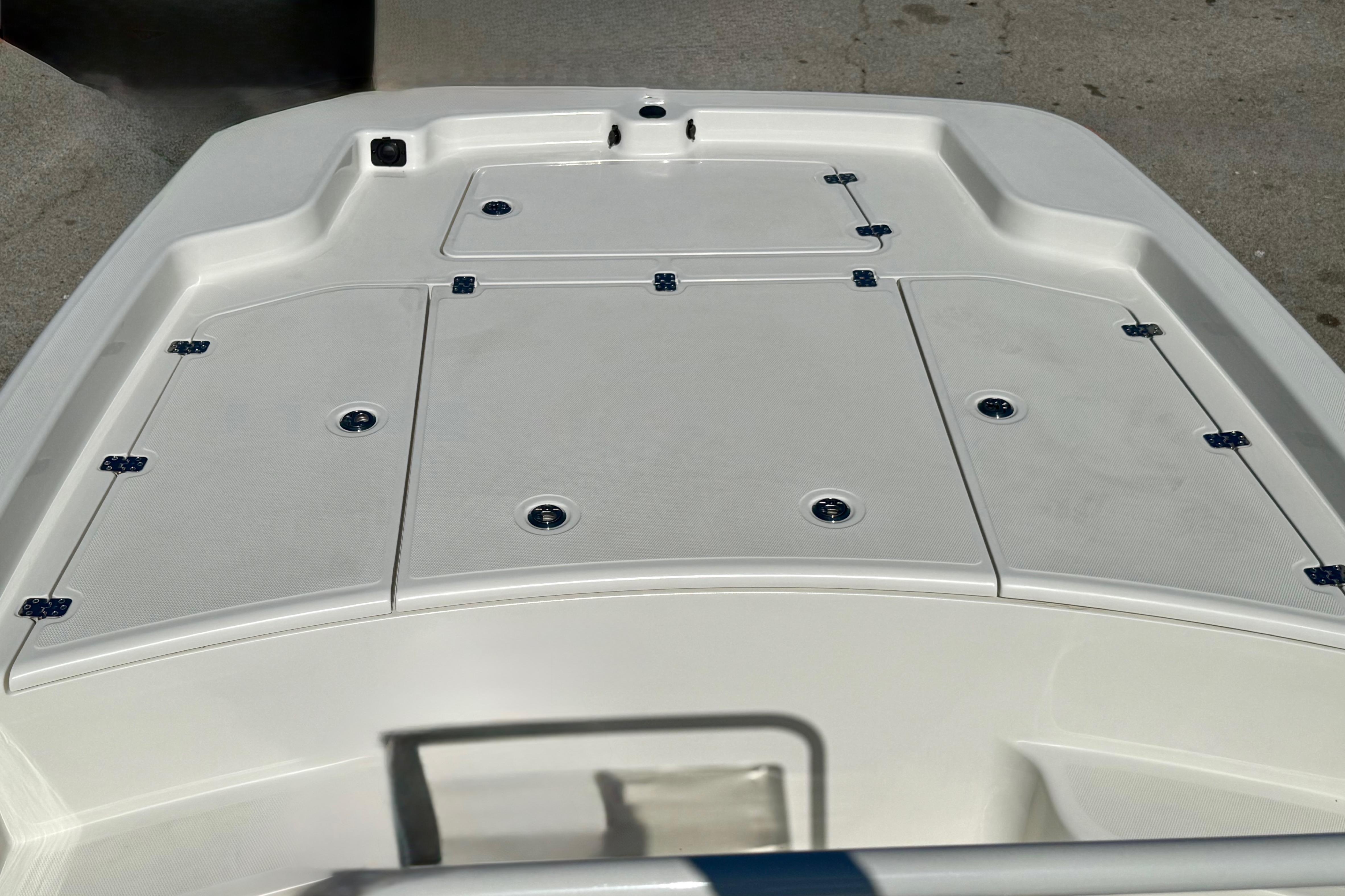 2024 Mako Pro Skiff 19 CC boat deck with storage compartments.