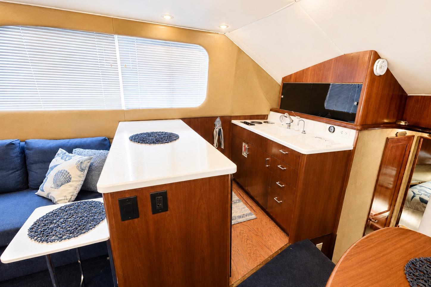 Interior of 1995 Ocean Yachts 42 Super Sport with modern kitchen and cozy seating area.