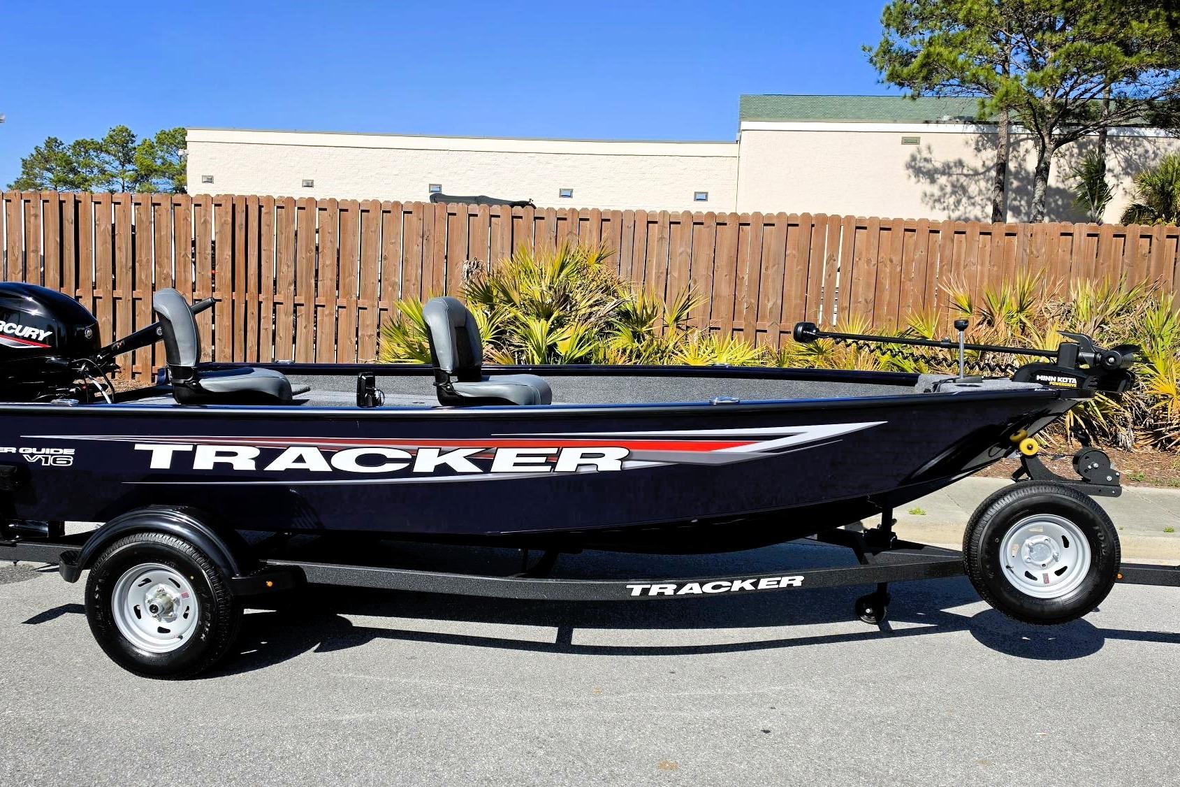 2026 Tracker Super Guide V-16 T boat on trailer, parked outdoors.