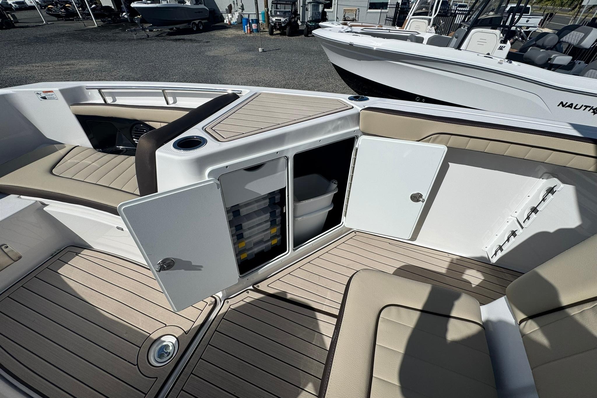 2026 Yamaha Boats 255 FSH Sport H interior with open storage compartments and seating.