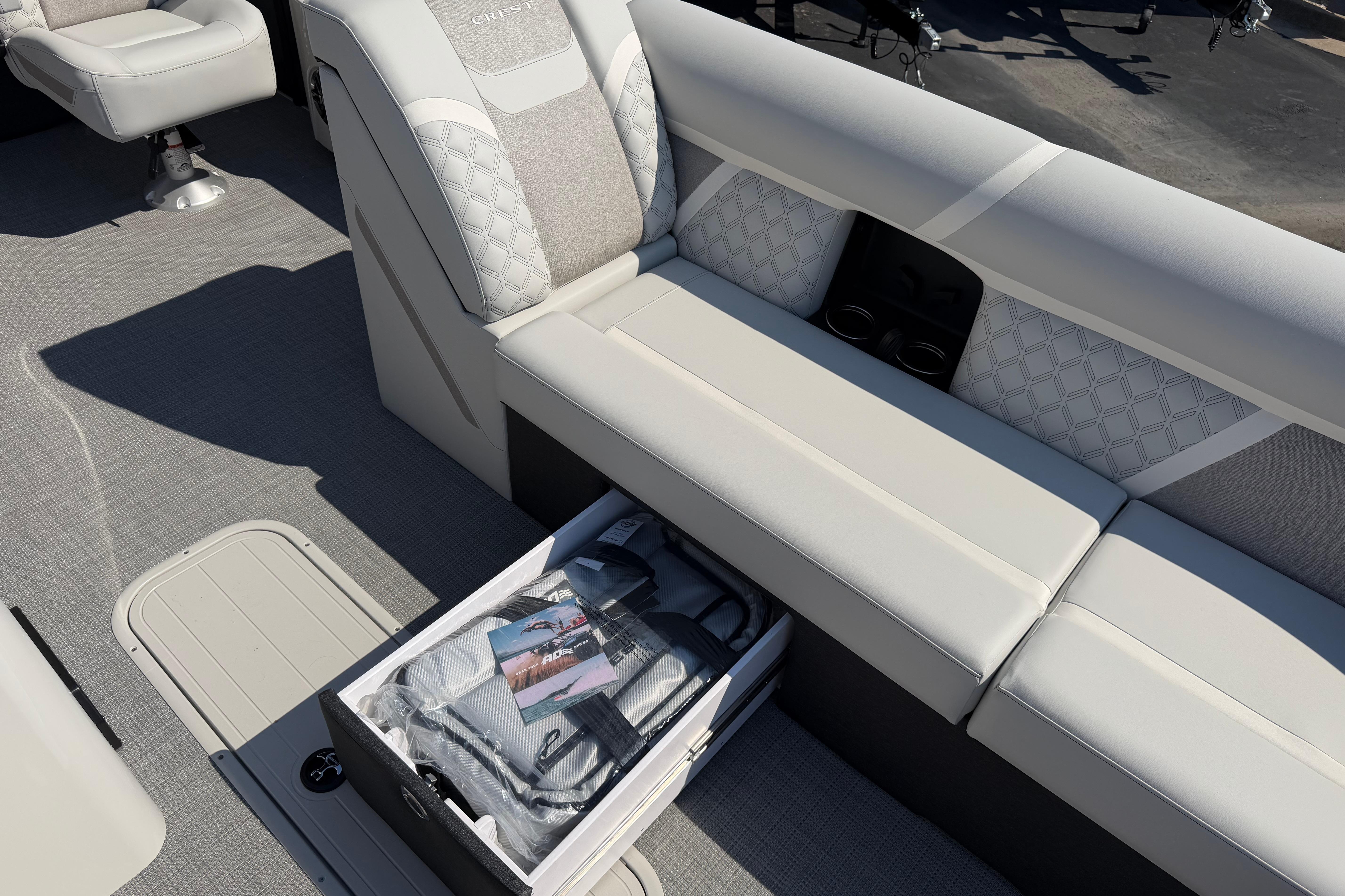 2026 Crest Conquest 250 SLSC boat interior with storage compartment and seating.