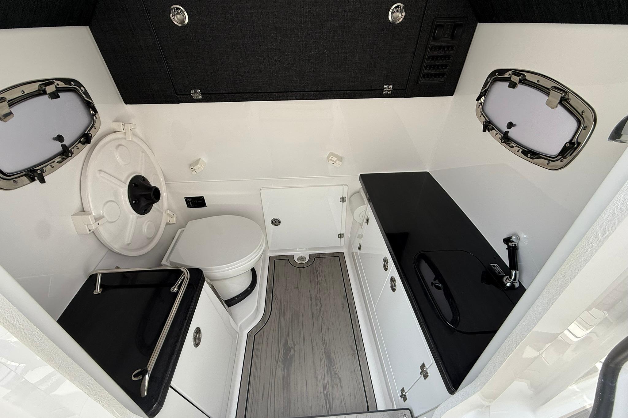 2027 Monterey Elite 30 OB boat interior with modern bathroom and sleek black countertops.