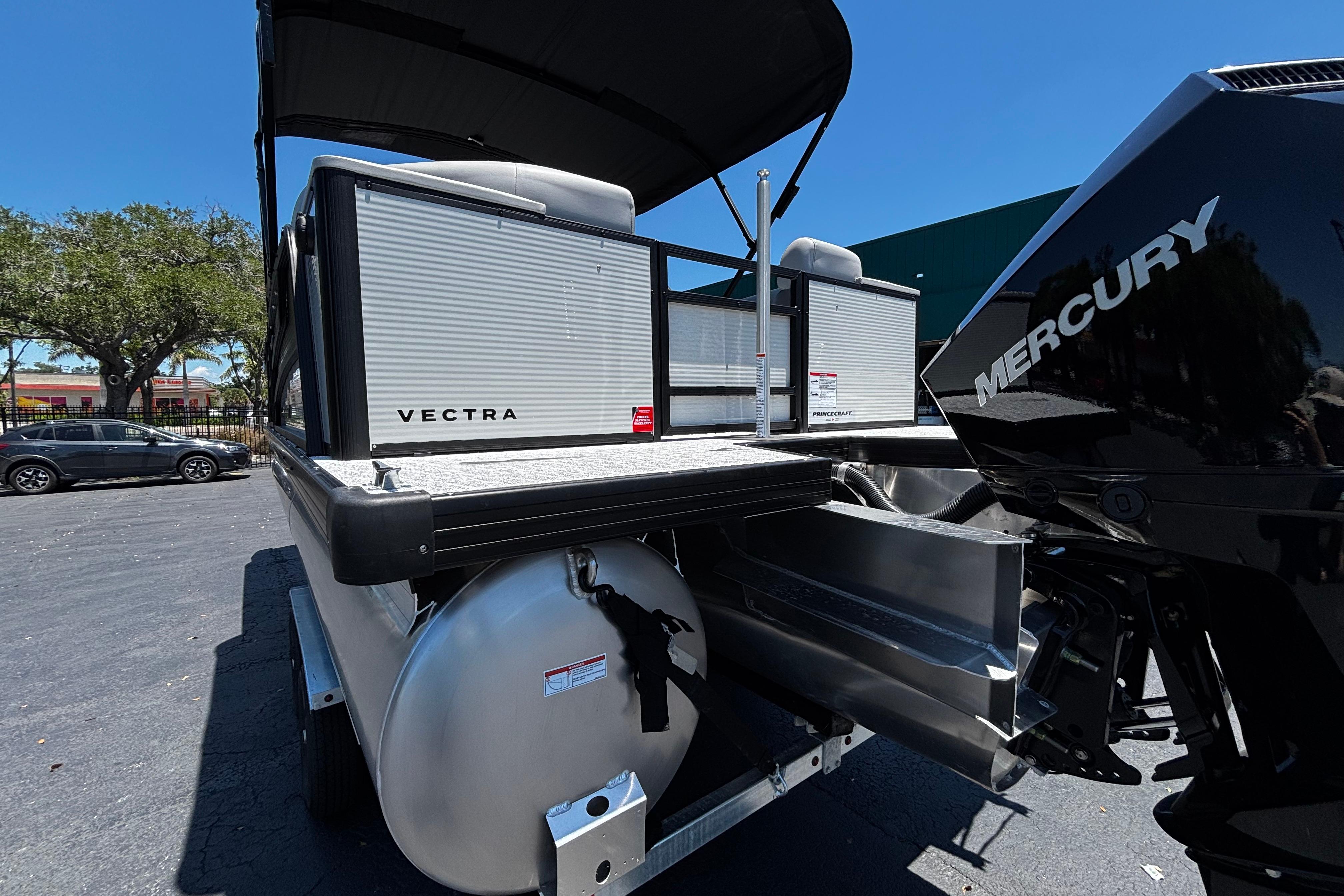 2026 Princecraft Vectra 23 QL pontoon boat with Mercury engine, parked outdoors.