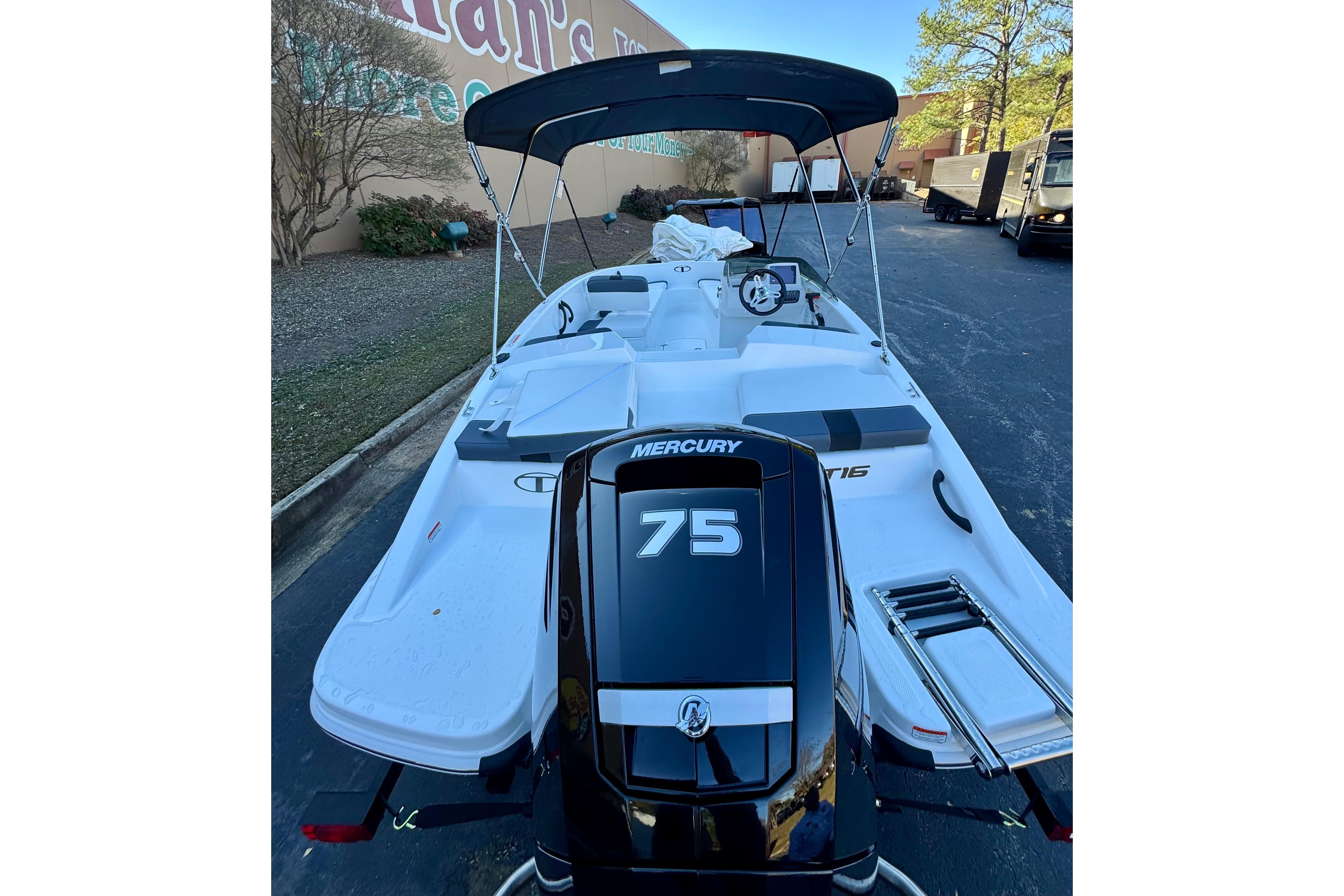 2026 Tahoe T16 boat with Mercury 75 engine, parked outdoors.