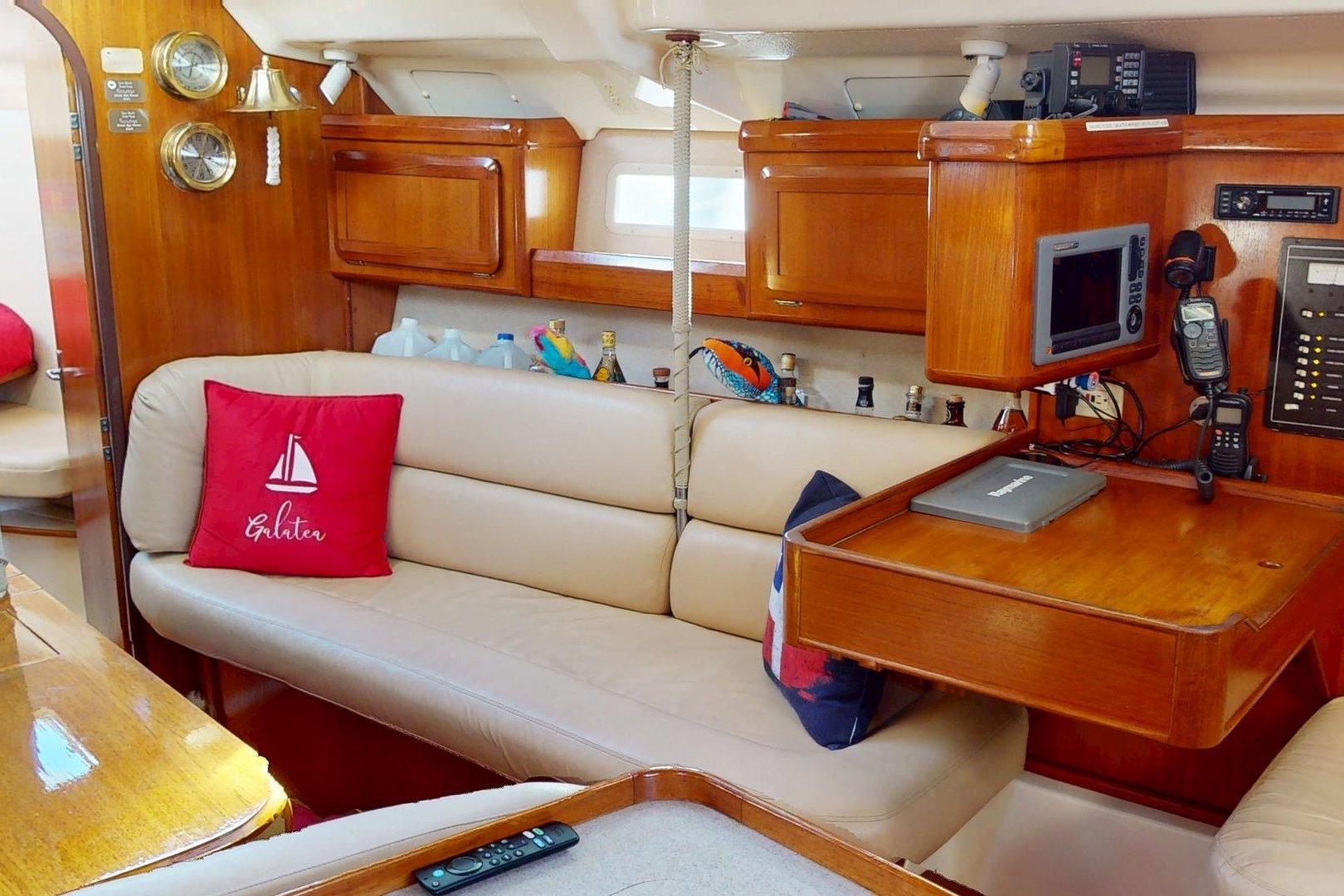 Interior of 1997 Hunter Legend 40.5 yacht with cozy seating and navigation equipment.