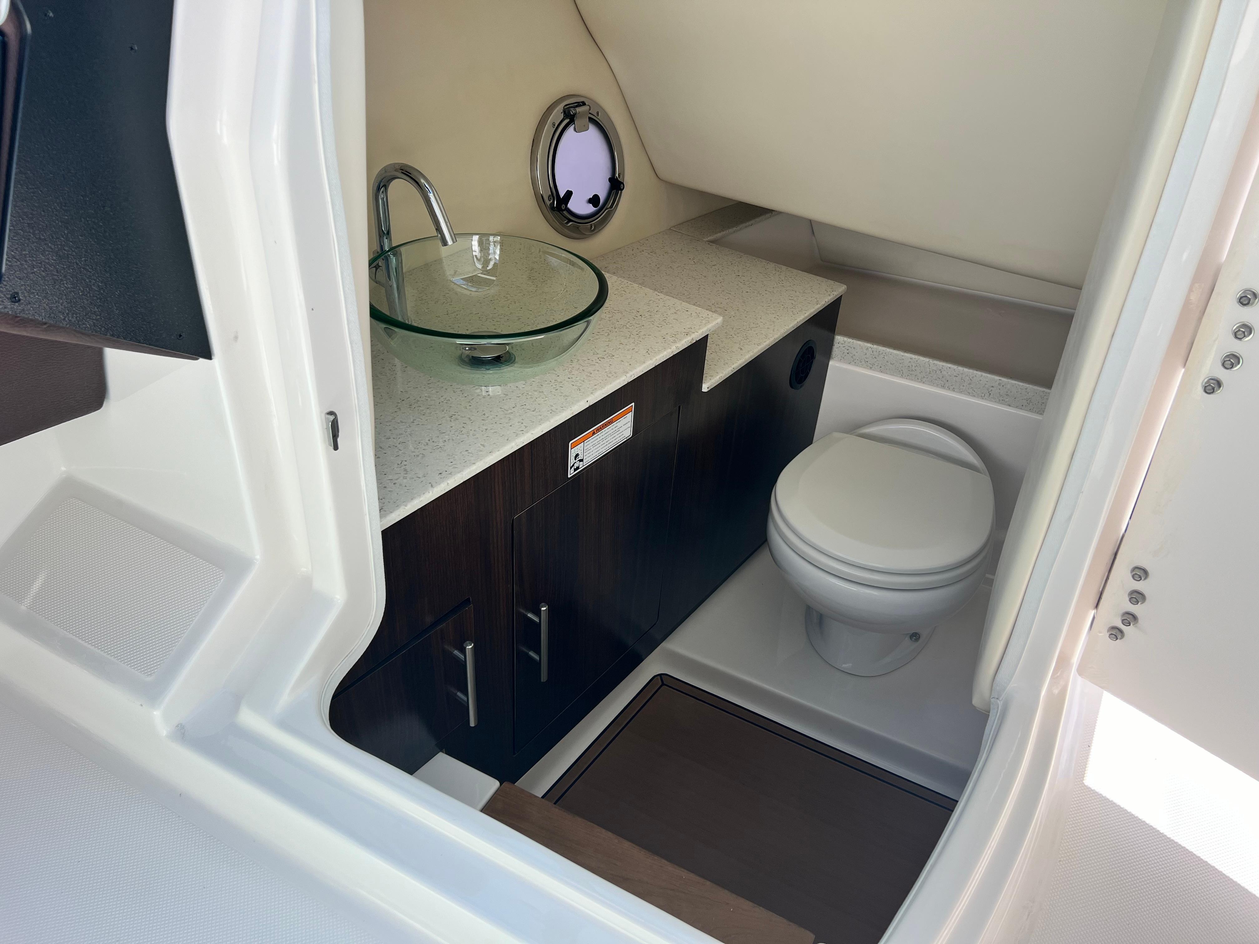 2016 Regal 3200 Bowrider boat bathroom with modern sink and toilet.