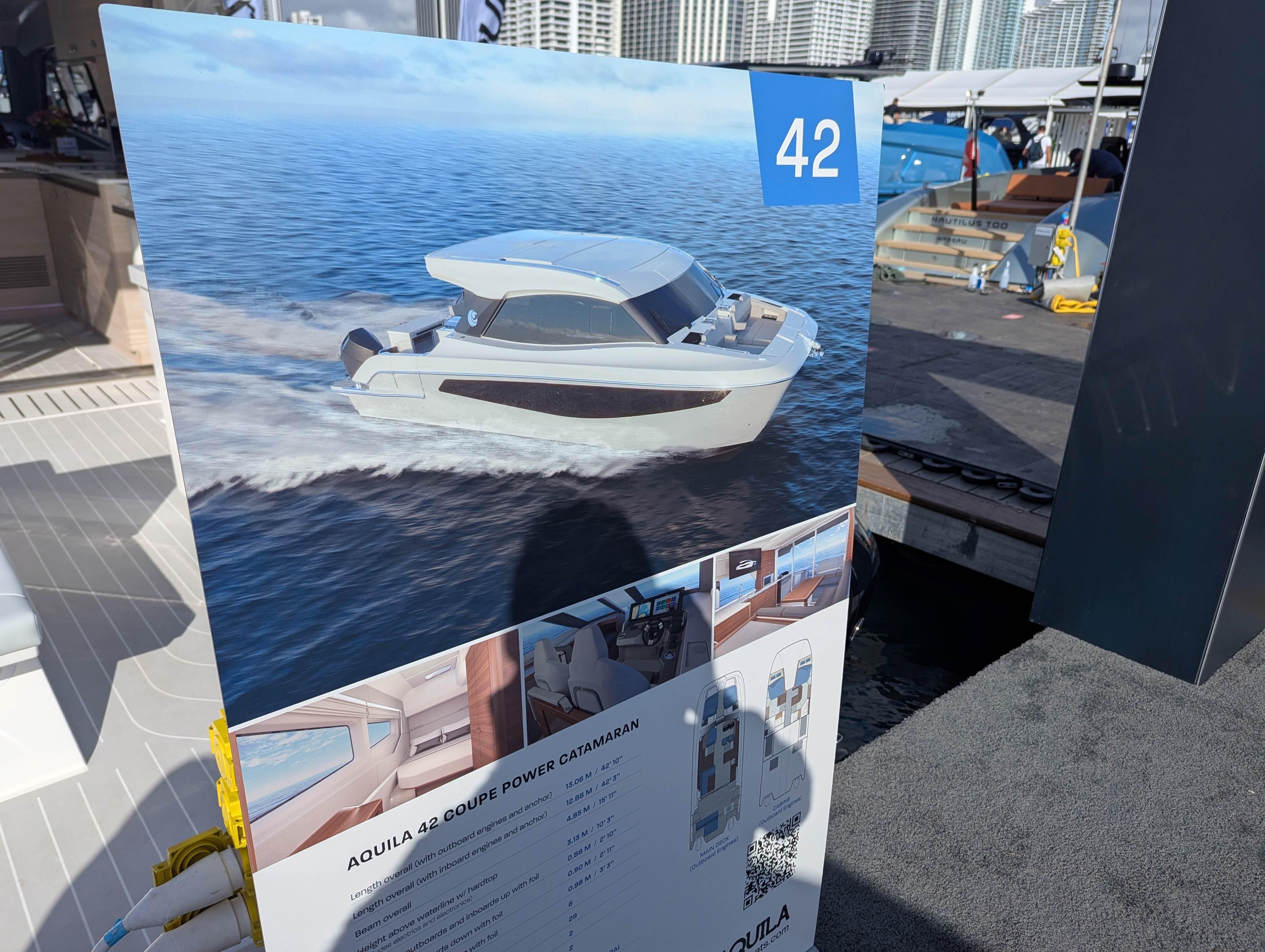 Aquila 42 Coupe 2026 catamaran display at a boat show, featuring sleek design and specifications.
