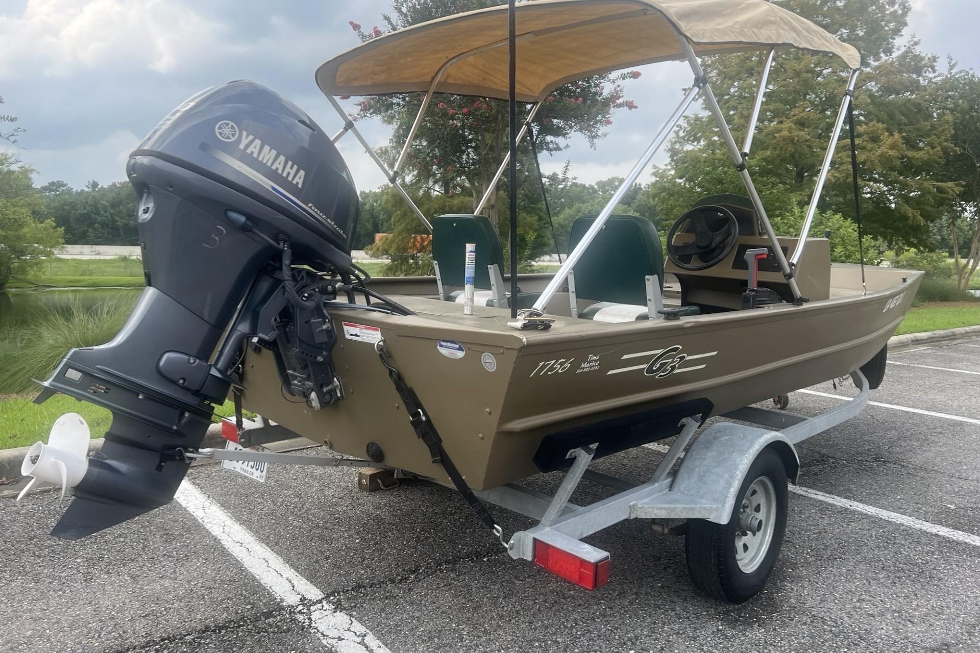 2016 G3 1756 SC boat with Yamaha outboard motor on trailer in parking lot.