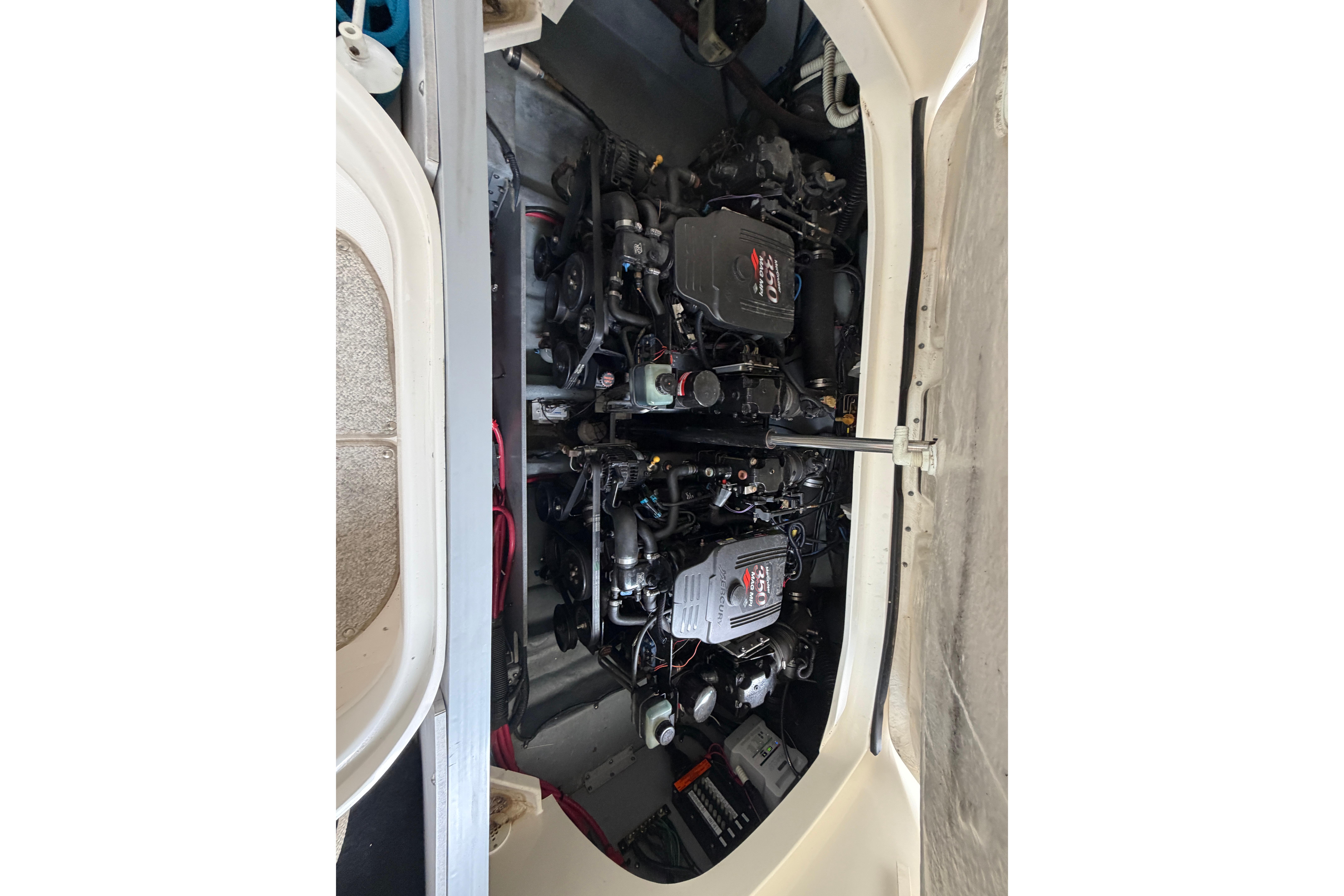 Engine compartment of a 2003 Sea Ray 290 Bowrider boat, showcasing dual engines.