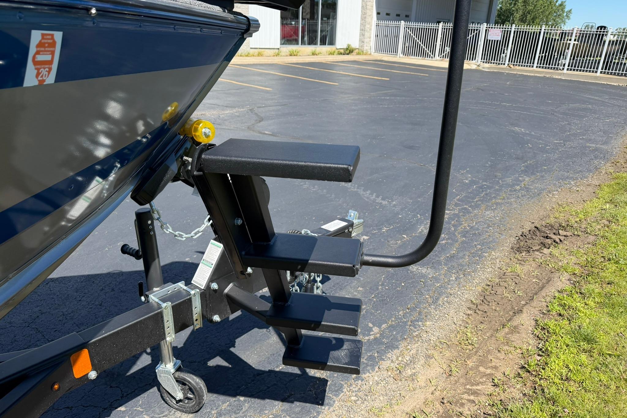 2024 Lund 1875 Impact XS Sport boat trailer with attached boarding ladder.