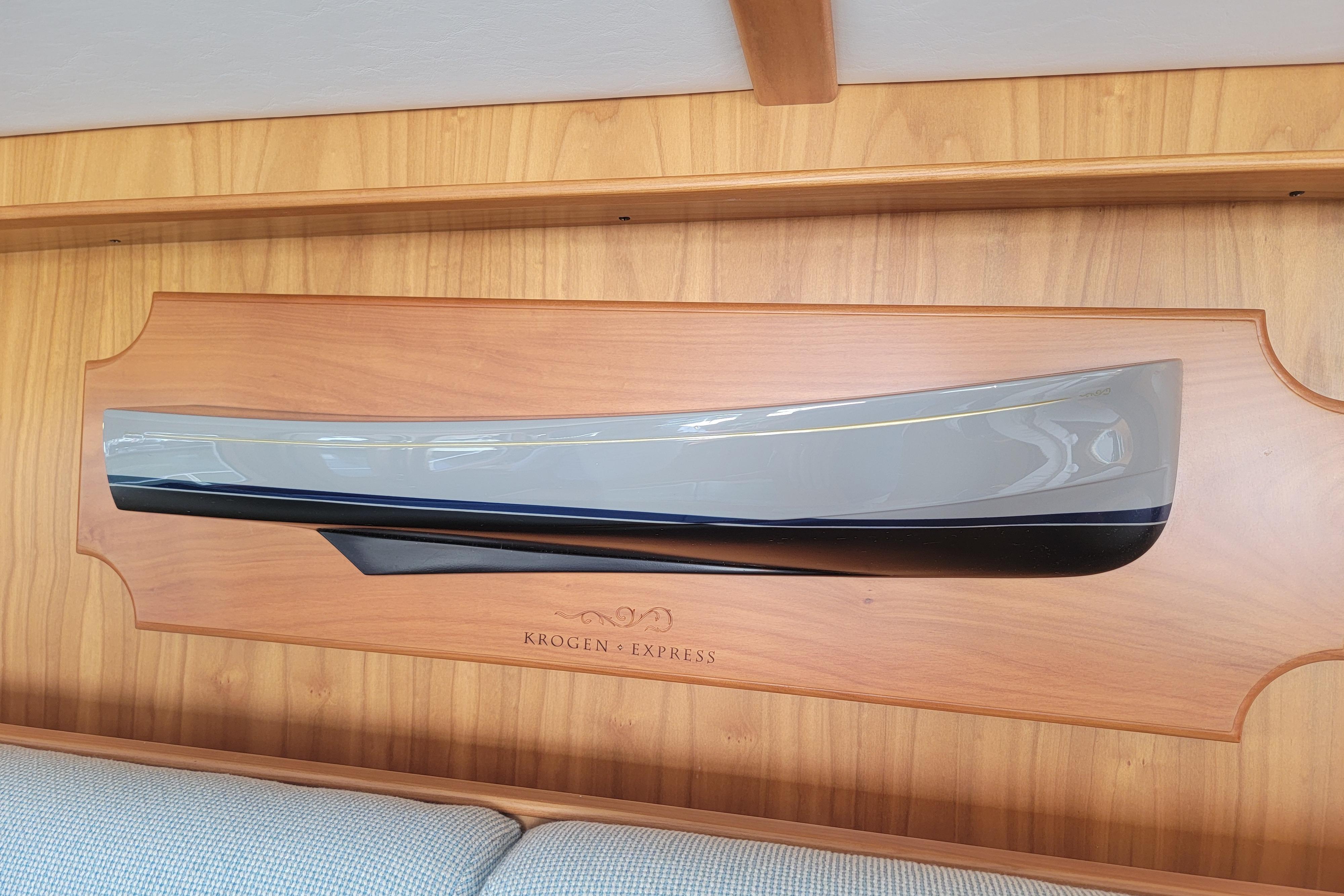 Model of 2023 Krogen Express 52' yacht displayed on wooden plaque.