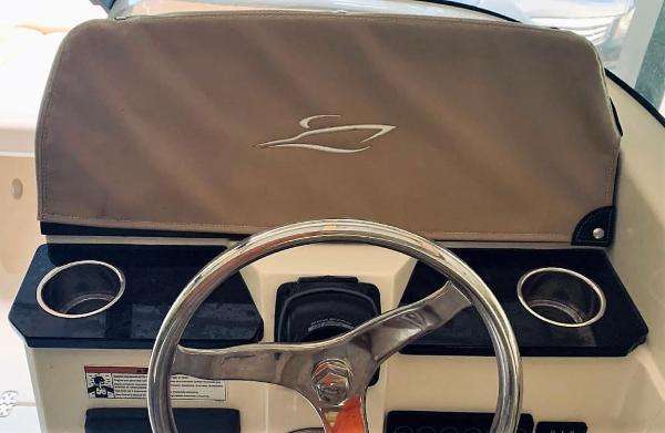 2025 Scout 215 Dorado boat dashboard with steering wheel and cup holders.