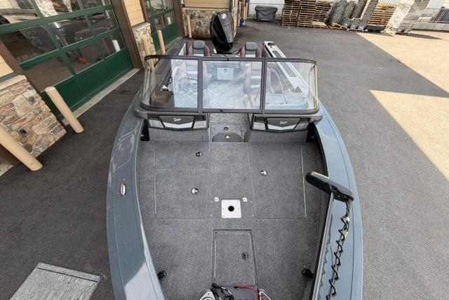 2026 Ranger VX1988 WT boat with spacious deck and windshield, parked outdoors.